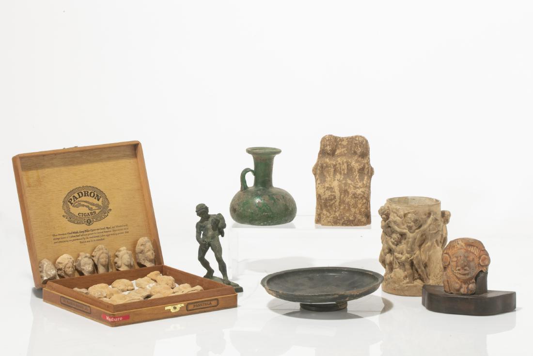 Collection of Ancient pottery, metalware & glass: A collection of pottery, metalware and glass antiquities and reproductions Etruscan, Roman and others Comprising 30 votive heads, a group of two seated figures, a bronze figure of a youth, a cup decor