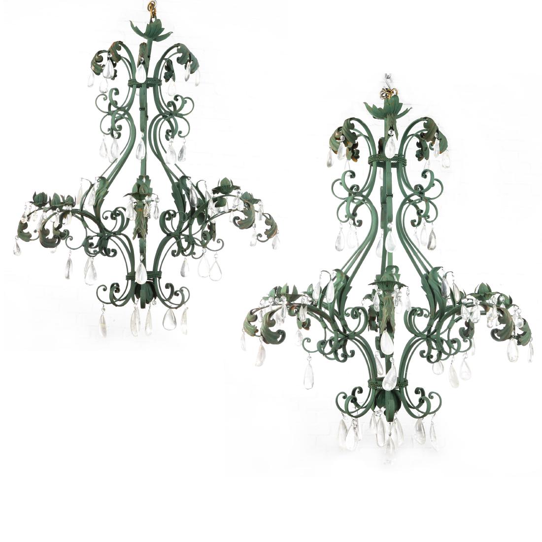 A pair of Rococo style eight light chandeliers: A pair of Rococo style green painted wrought metal and tÃ´le and rock crystal eight light chandeliers post 1950 Slight variation in color. height approximately 44in (112cm); diameter approximately 3