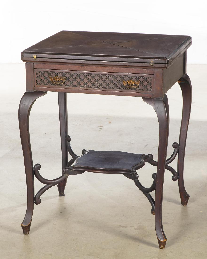 A Louis XV style mahogany games table: A Rococo style mahogany envelope games table late 19th/early 20th century height 28 1/2in (72.5cm); width 21 3/4in; (55.5cm); depth 22in (56cm)