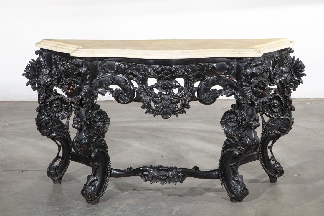 A Rococo style ebonized and faux marble console: A Rococo style ebonized and faux marble console post 1950 height 30 1/2in (77.5cm); width 57in (145cm); depth 20 1/4in (51cm) Provenance: Property from the Collection of Lauren King.
