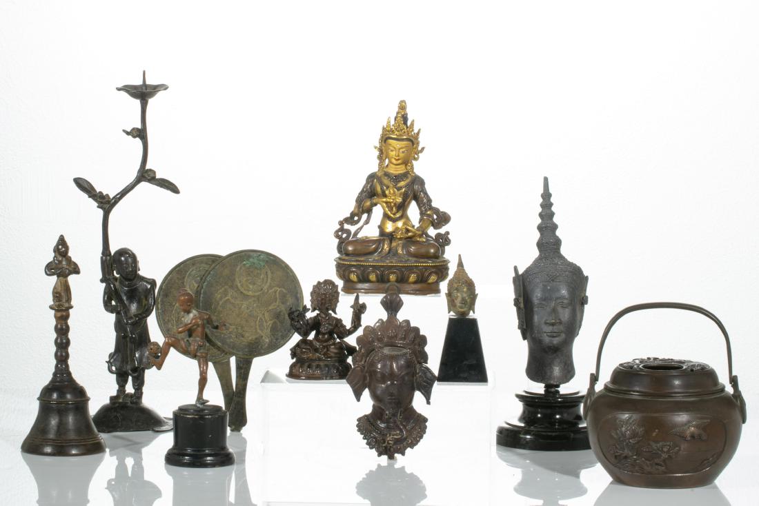 An eleven piece group of Asian metalware objects: An eleven piece group of Asian metalware objects 17th-20th century Comprising three Indian figures. two Chinese hand mirrors, Japanese figural pricket, a Japanese hand warmer, a Japanese figure with a