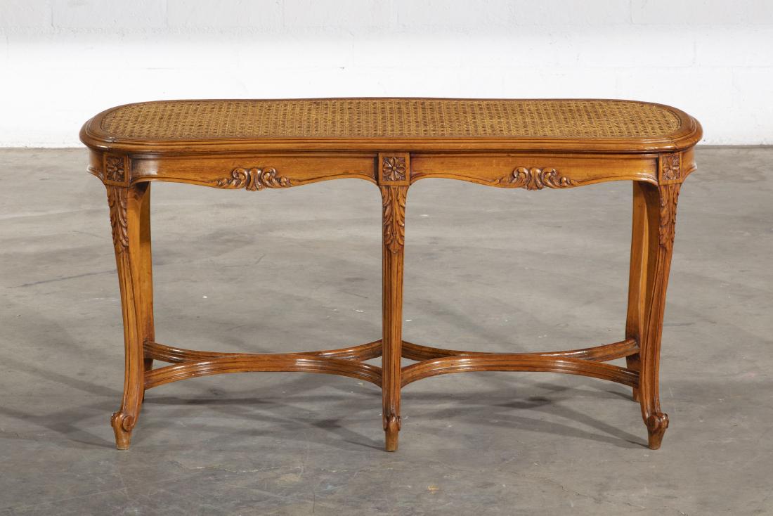 A Louis XV style beechwood window bench: A Louis XV style carved beechwood and caned window bench early 20th century height 20in (51cm); width 39in (99cm); depth 14 3/4in (37.5cm)