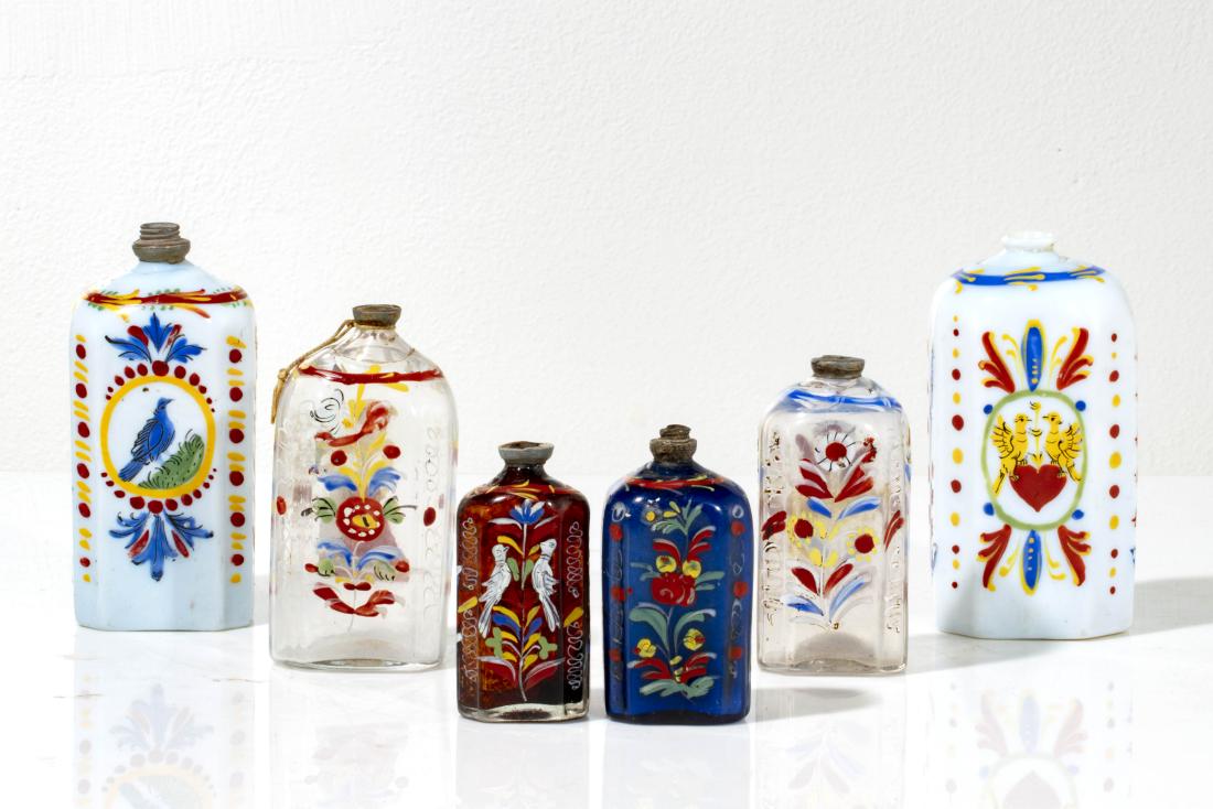 Six Stiegel type enameled glass bottles: A collection of six Stiegel type enameled glass bottles 19th century the largest height 6 1/4in (16cm)