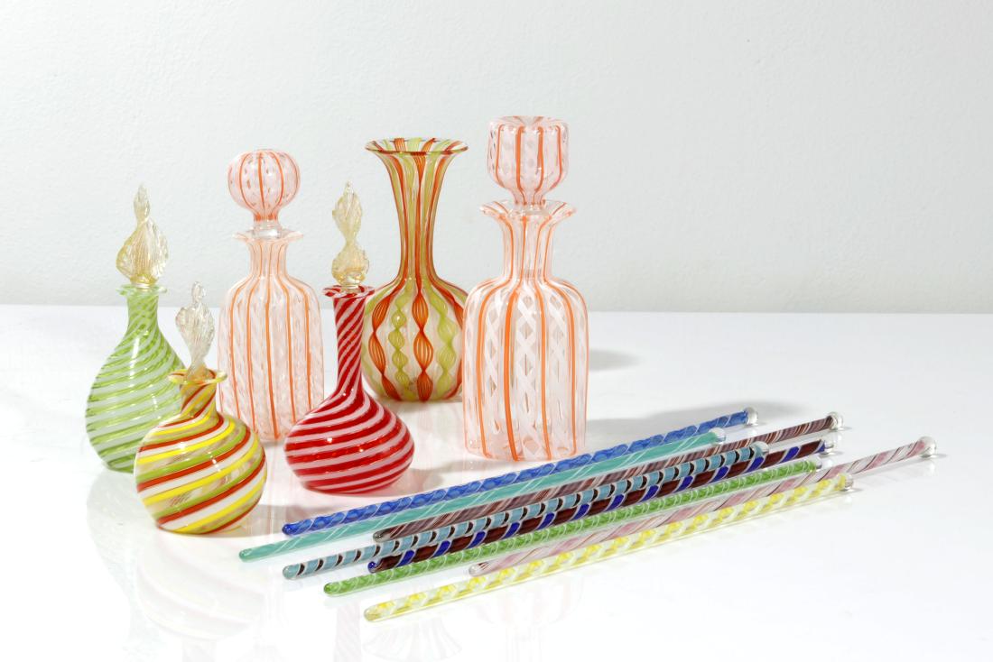 A collection of Venetian glass table articles: A fourteen piece collection of Venetian glass table articles 20th century Comprising a vase, five bottles and eight batons. the largest bottle height 7 3/4in (19 1/2cm)