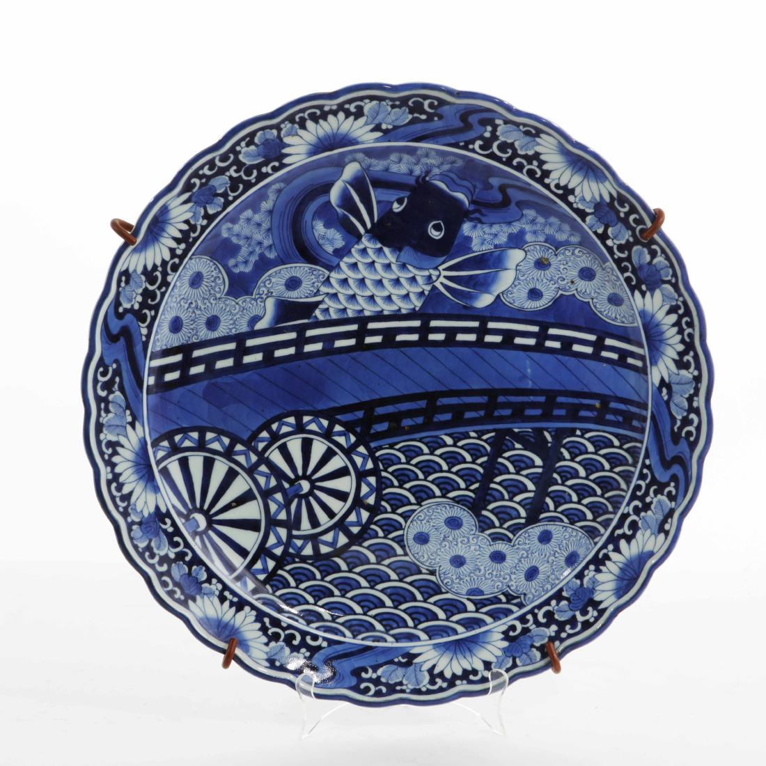 A Japanese porcelain blue and white charger: A Japanese porcelain blue and white charger first half 20th century diameter 19 1/2in (49.5cm)Provenance: Property from the Estate of Stephen L. Sayler, Newport Beach, California.