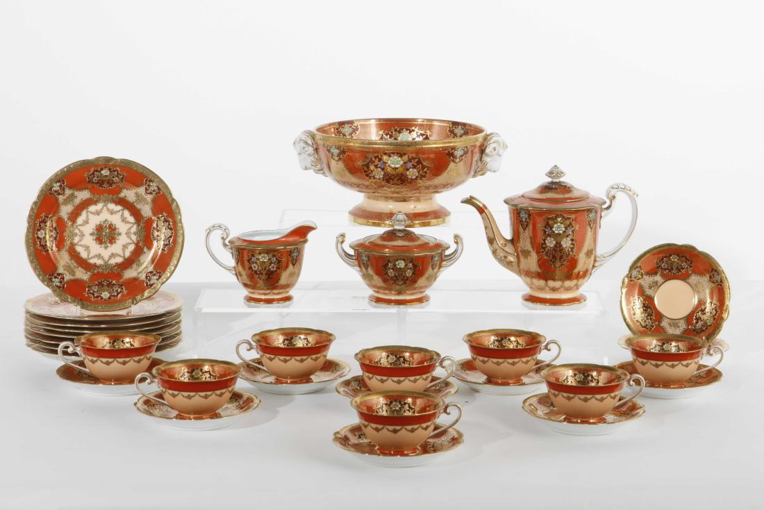 A Noritake porcelain part tea and dessert service: A Noritake gilt heightened and enamel decorated porcelain part tea and dessert service 20th century Comprising teapot, height 6 3/4in; covered sugar; creamer; ten teacups and saucers; eight 7 3/4in pl