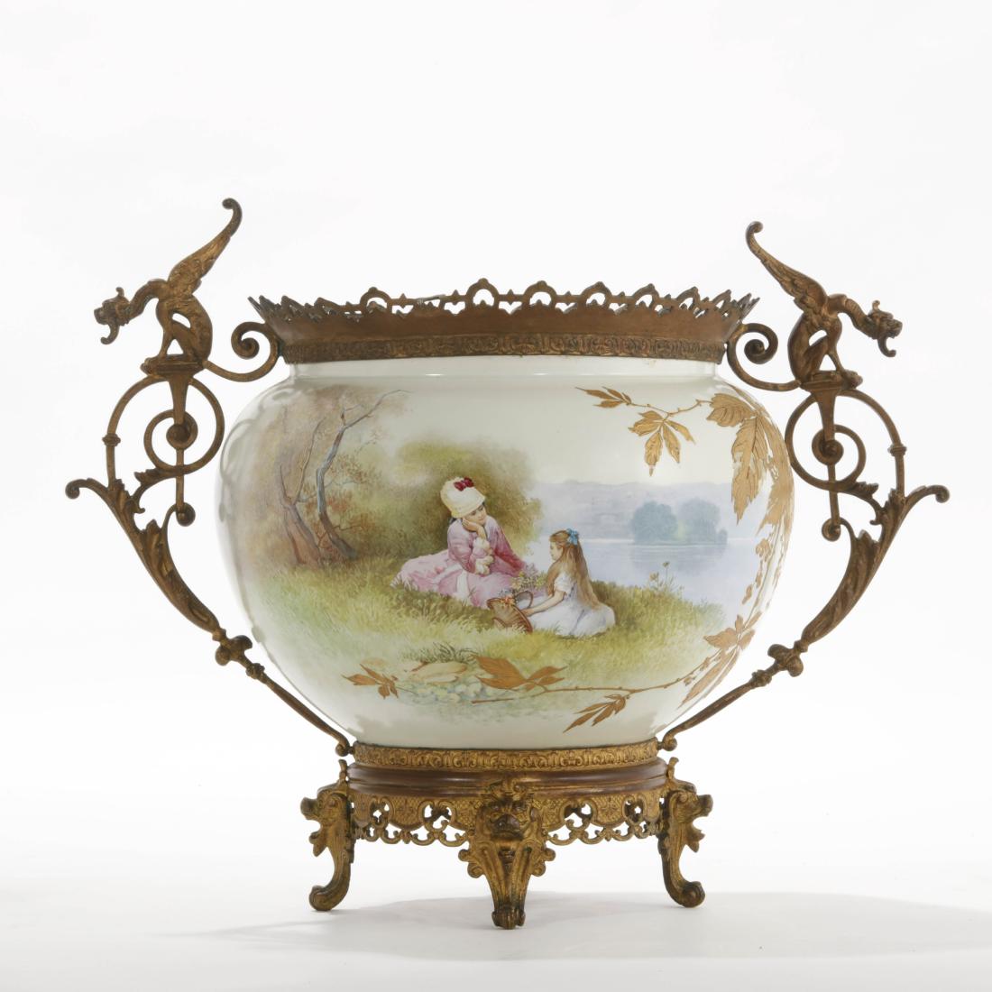 A French gilt bronze and earthenware center bowl: A French gilt bronze mounted glazed earthenware center bowl height 12 1/4in (31cm); width over handles 17in (43cm)