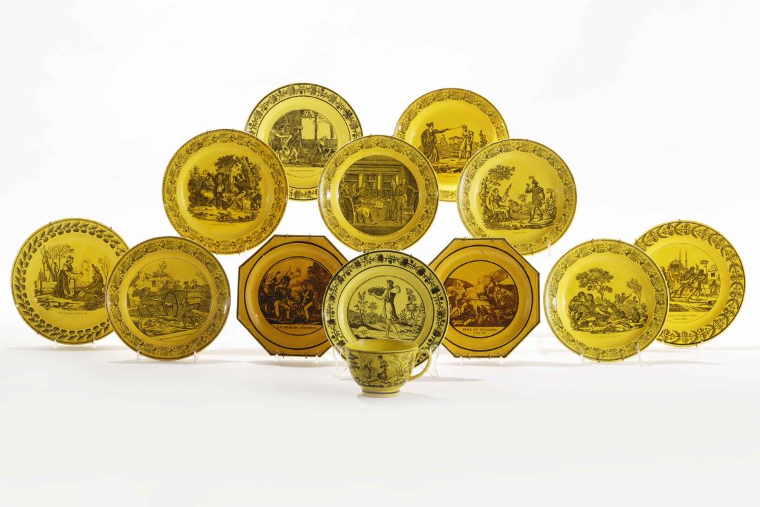 Thirteen pieces of French yellow glazed earthenware: Thirteen pieces of French transfer decorated yellow glazed earthenware tableware Comprising two octagonal plates, ten other plates and a teacup, various impressed factory marks. diameter of largest 8 