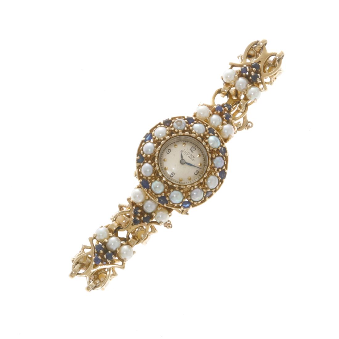A Lucien Piccard 14K gold ladys wristatch: A Lucien Piccard cultured pearl, gemstone and 14K gold lady's wristatch #A023520. length 6 3/4in (17cm); gross weight approximately 44.8 grams