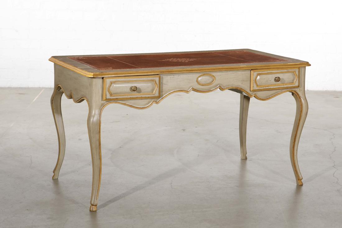 A Rococo style paint decorated writing table: A Continental Rococo style paint decorated writing table 20th century The top inset with a tooled leather writing panel. height 29 3/4in (75.5cm); width 54 1/4in (138cm); depth 30 1/2in (77.5cm)