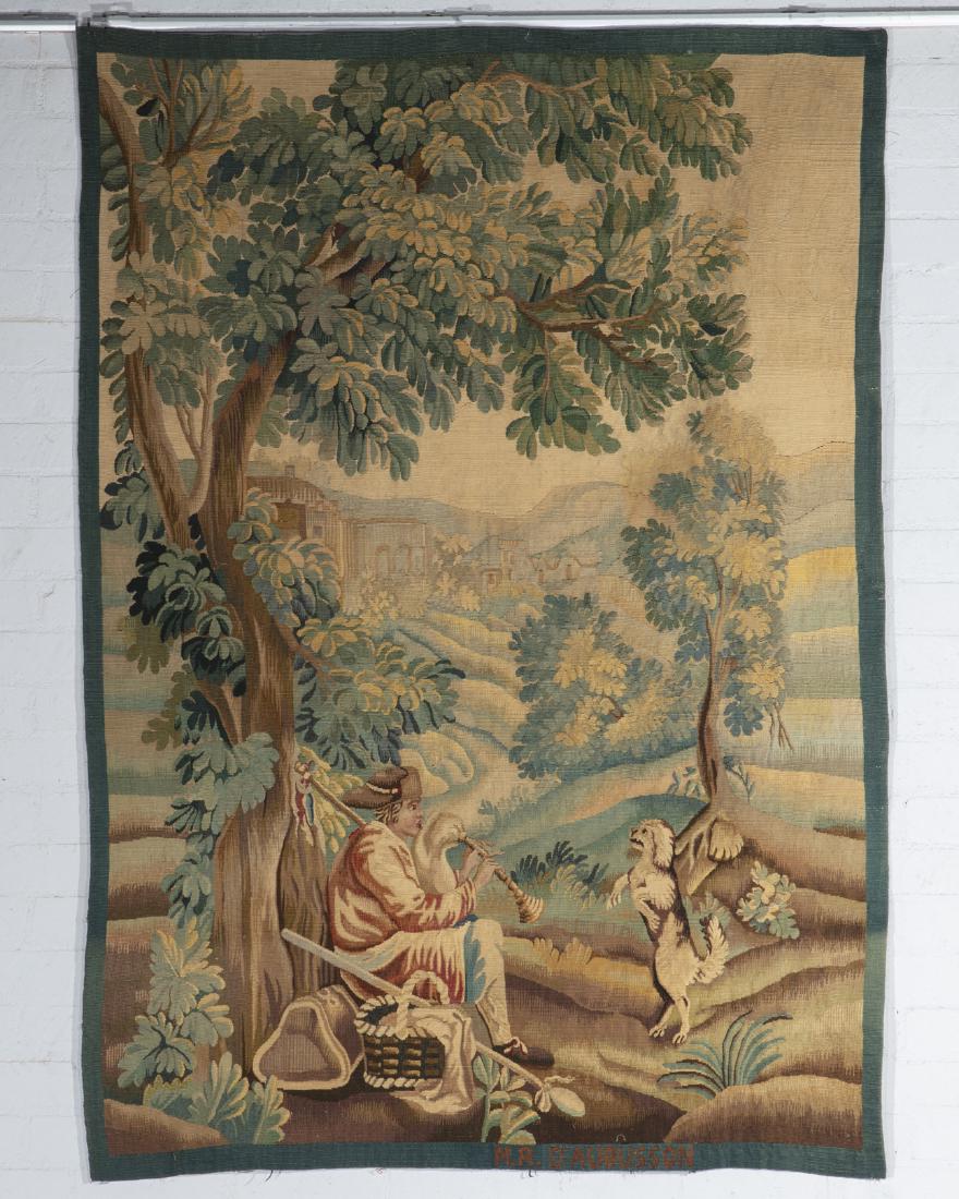 An Aubusson pastoral tapestry: An Aubusson pastoral tapestry Inscribed M.R. D'AUBUSSON 7ft x 4ft 9in (213 x 145cm)Provenance: Property from the Estate of Jack Levin, Los Angeles, California.