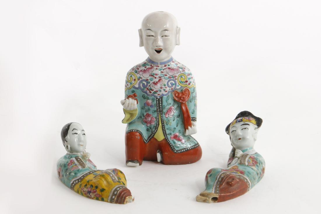 Four Chinese ceramic and wood figures: Four Chinese ceramic and wood figures late 19th-20th century Comprising an articulated opera puppet doll, a figure of a boy and two recumbent figures. the puppet height 13in (33cm)