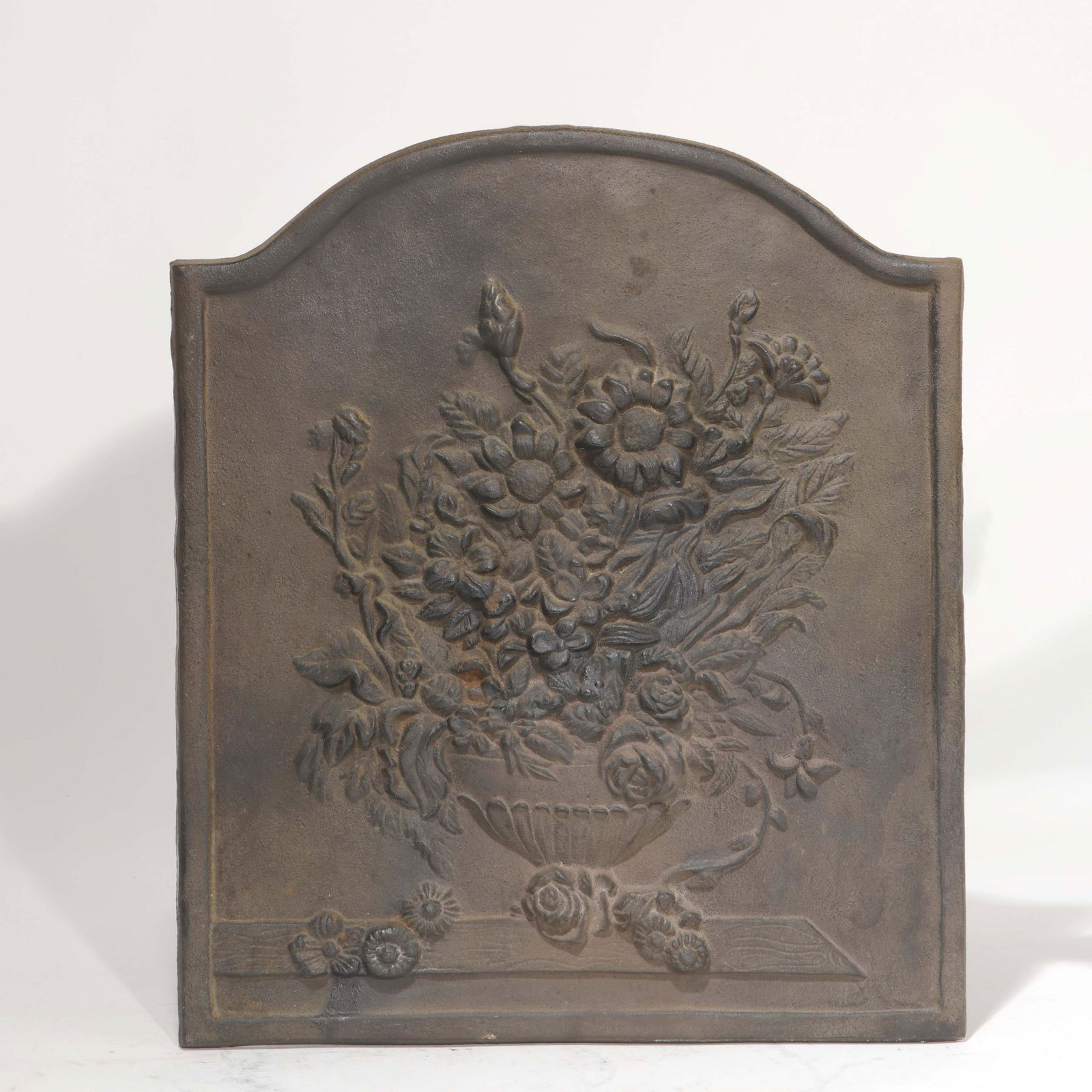 A Continental Baroque style cast iron fireback: A Continental Baroque style cast iron fireback height 19 3/4in (50cm); width 17in (43cm)Provenance: Property from The McNally Company Antiques, Rancho Santa Fe, California.