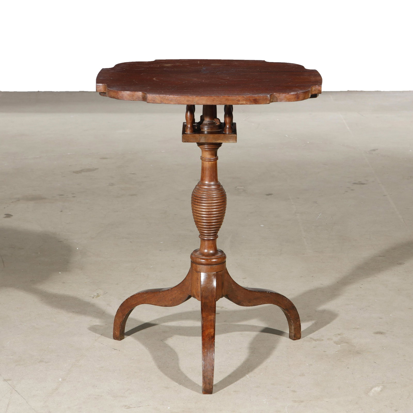 A Federal mahogany bird cage tilt top tea table: A Federal mahogany bird cage tilt top tea table second quarter 19th century height 27 1/4in (69cm); width 20 3/4in (52.5cm); depth 18 1/4in (cm)Provenance: Property from the Schutzenberger Family Coll