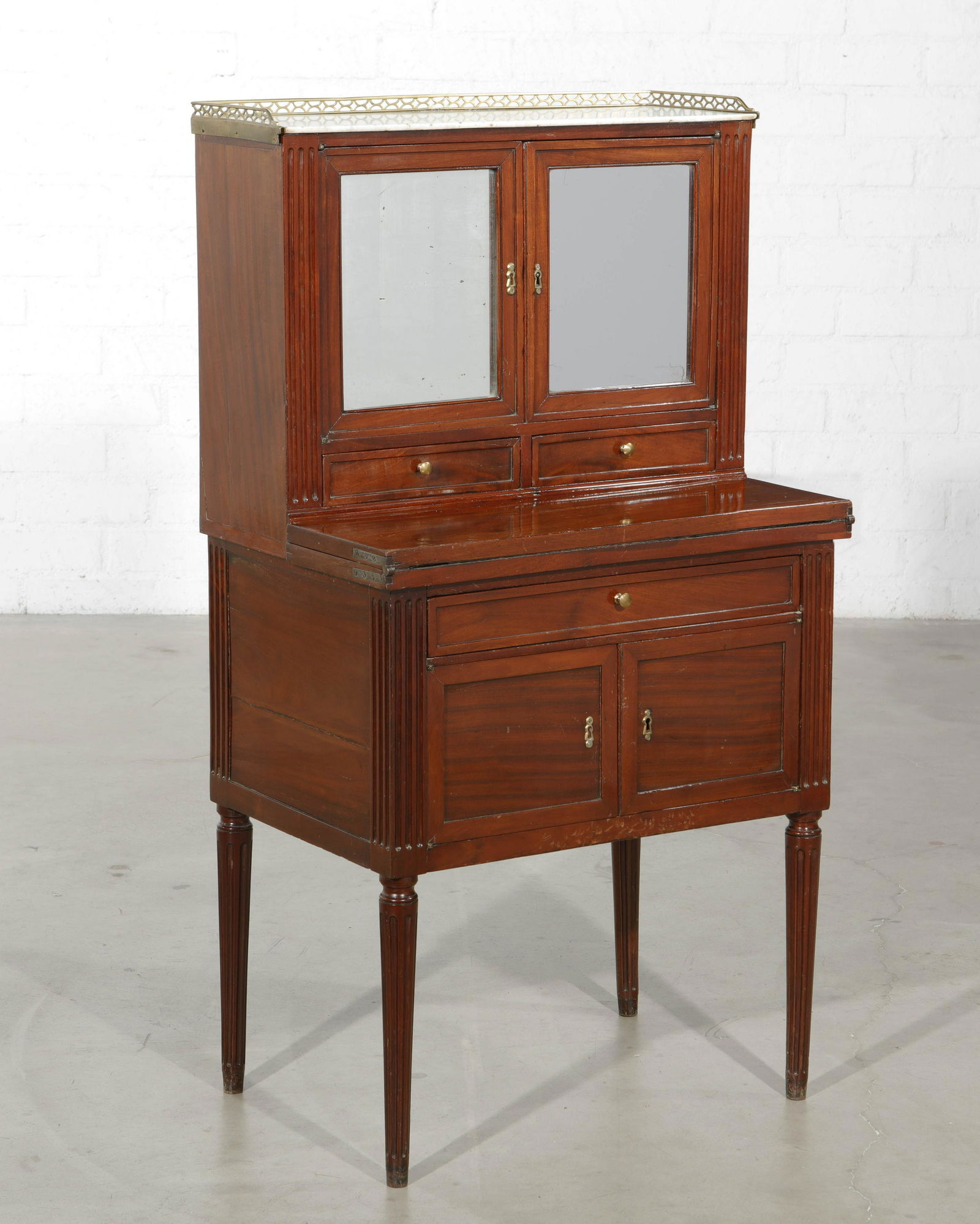 A Directoire mahogany bonheur du jour: A Directoire mahogany bonheur du jour late 18th century height 47in (119.5cm); width 25 3/4in (65.5cm); depth 17 1/4in (43.5cm)Provenance: Property from a Private Collection, Altadena, California.