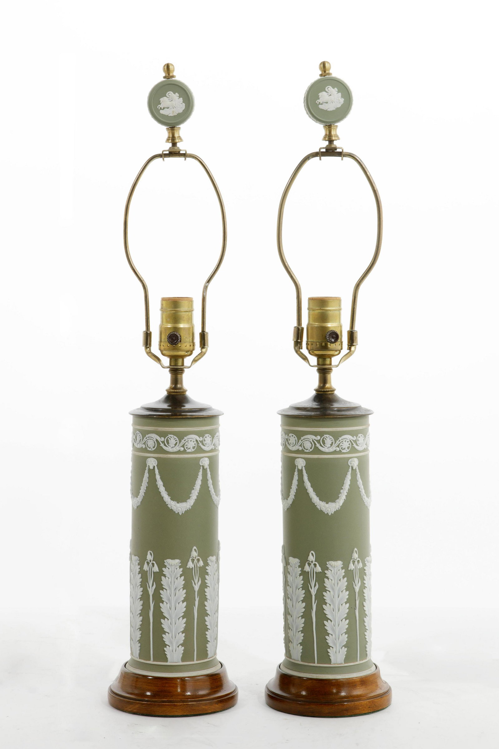 A pair of Wedgwood olive green jasperware lamps: A pair of brass mounted Wedgwood olive green jasperware table lamps 20th century height to finial 23in (58.5cm)Provenance: Property from the Estate of Richard E. Faggioli.