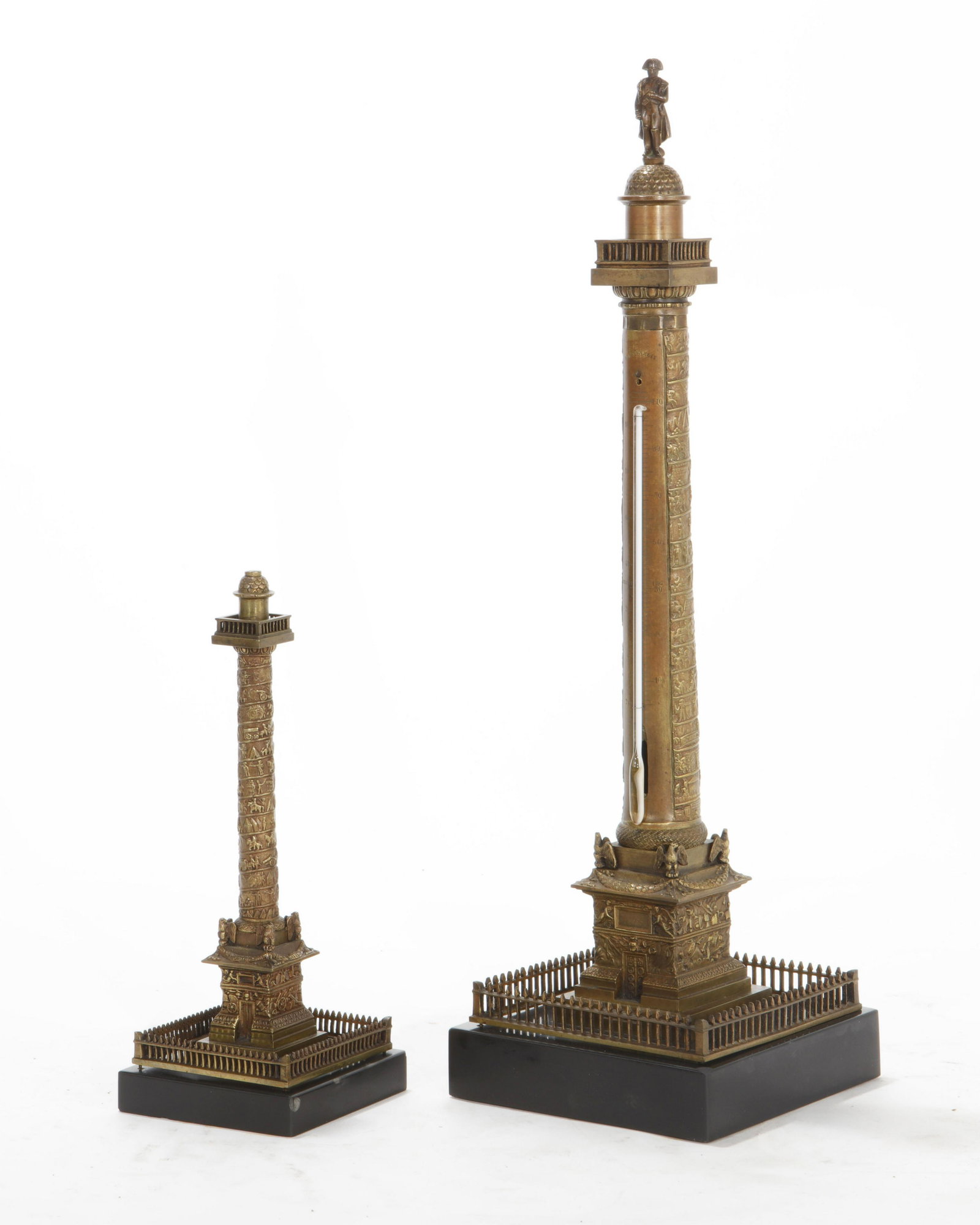 A French bronze model of the Colonne Vendome: A French patinated bronze Grand Tour model of the Colonne Vendome with thermometer and a smaller example second half 19th century (2). height of taller 18 1/4in (46.5cm)
