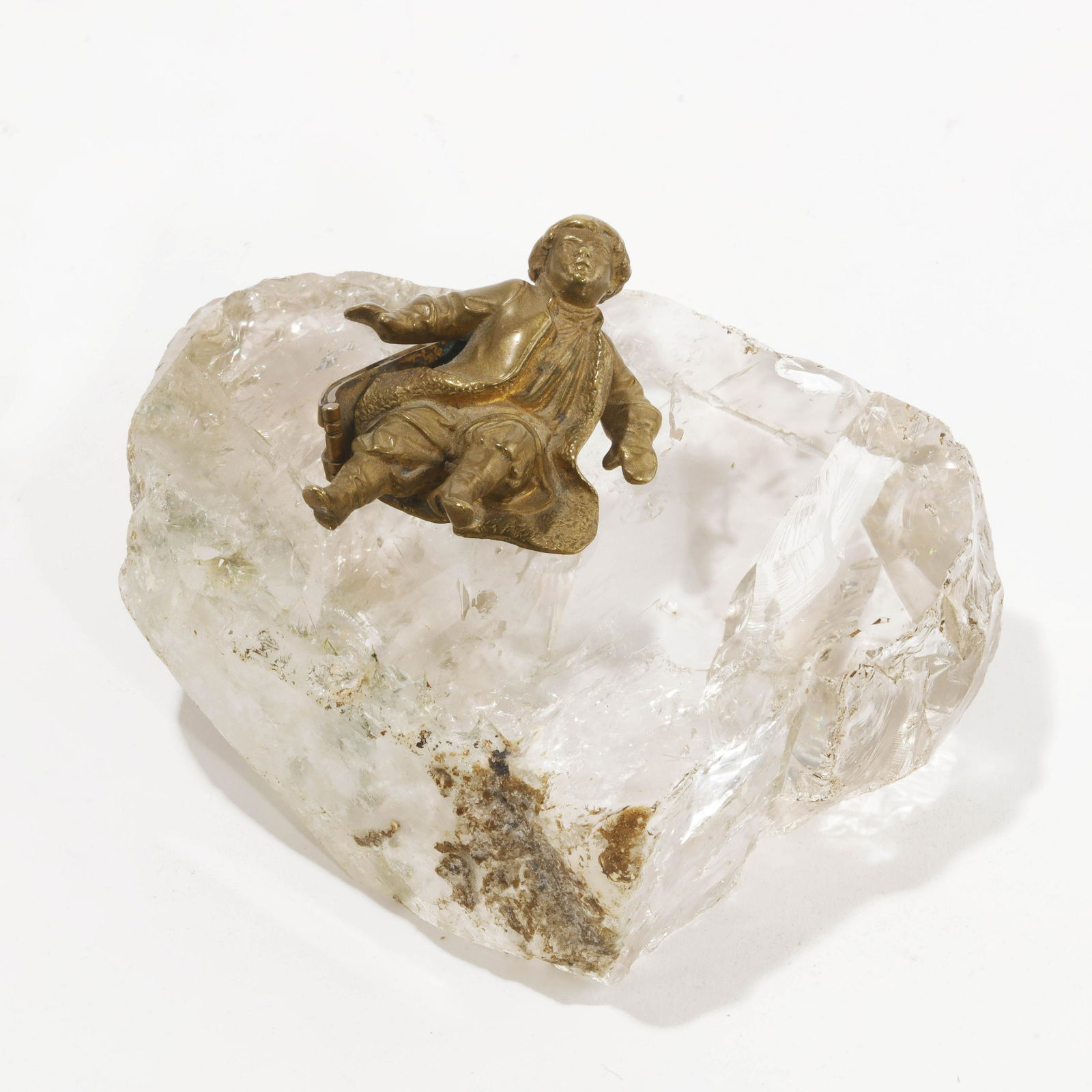 A Russian gilt bronze and rock crystal figure: A Russian gilt bronze and rock crystal figure of a boy slipping on ice late 19th/20th century height 2 1/2in (6.5cm); width 4 3/4in (12cm)