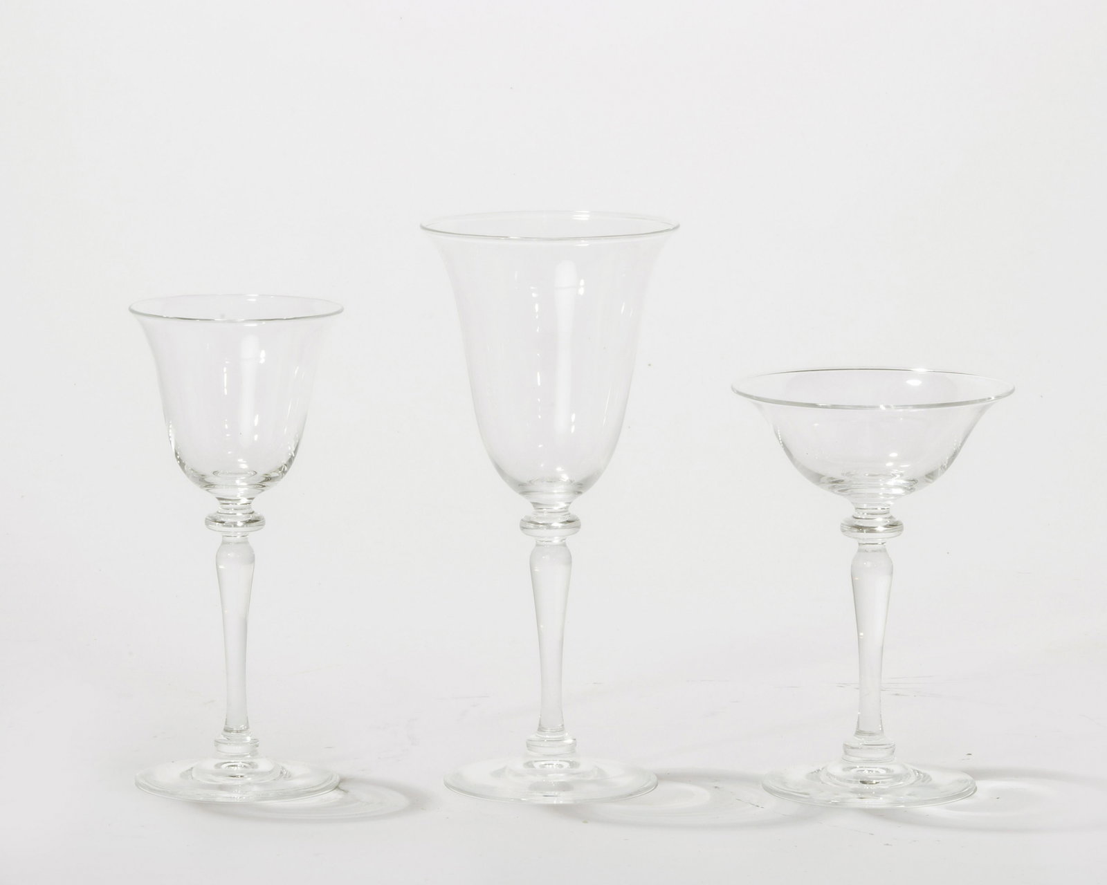 Suite of Steuben clear glass stemware: A suite of Steuben clear glass stemware Comprising ten 8 1/8in red wine glasses, twelve 6 7/8in white wine glasses and eleven 5 7/8in champagne coupes, etched S .