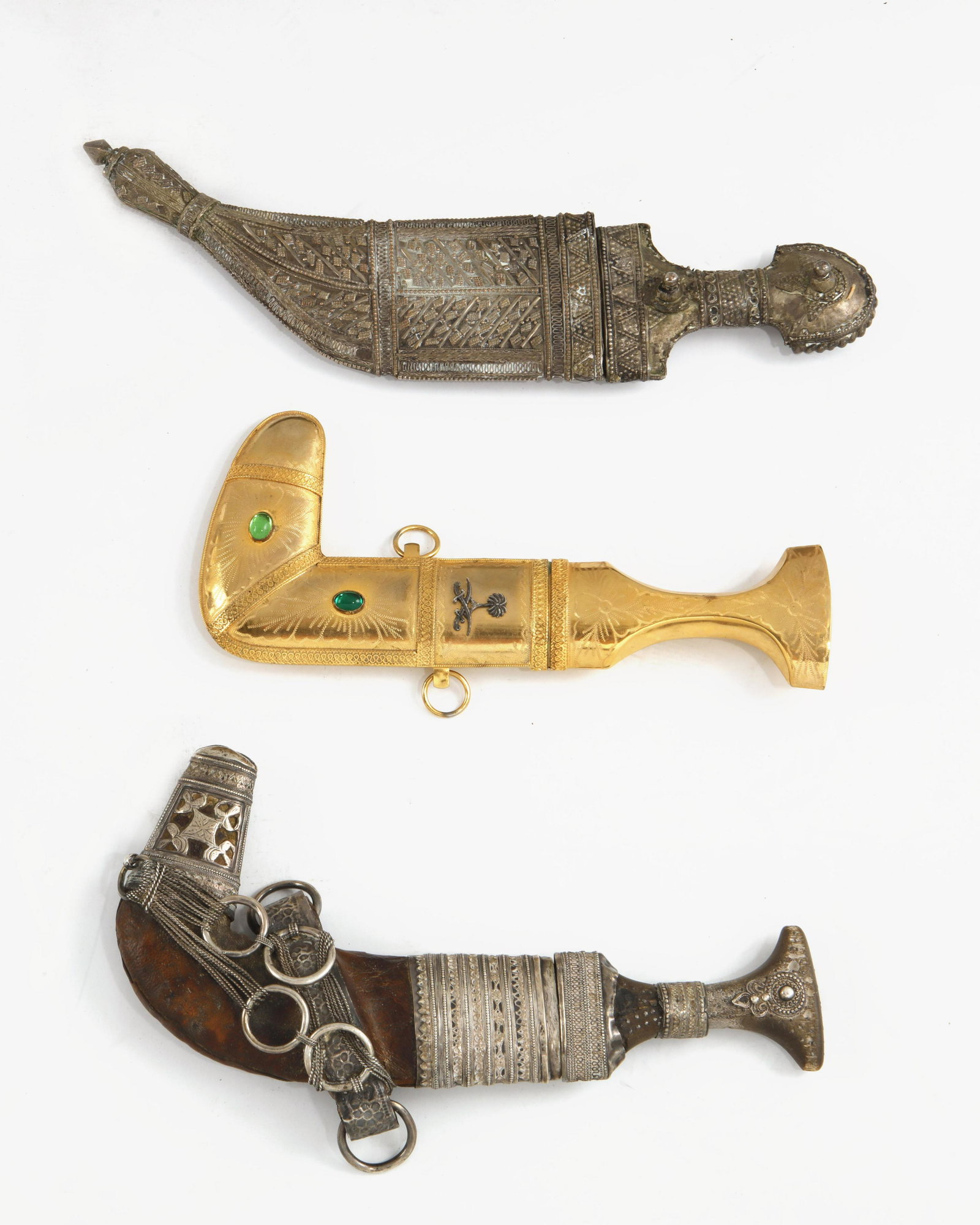 Three Saudi Arabian mixed metal daggers: A group of three Saudi Arabian mixed metal daggers lengths ranging 11in (28cm) to 15in (38cm)Provenance: Property from a Private Collection, Santa Barbara, California.