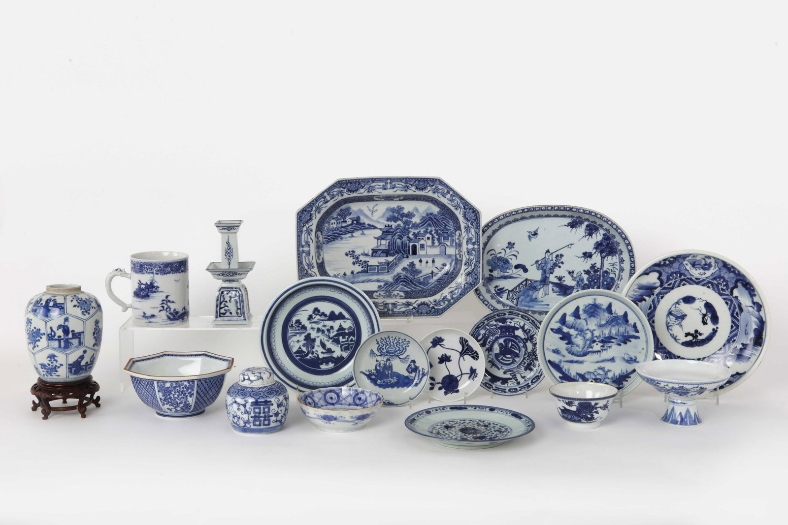 Sixteen pieces Asian blue and white porcelain: A sixteen piece collection of Chinese and Japanese blue and white porcelain 19th-20th century Including dishes, bowls, a tankard, a tea caddy and a jar; together with a Mottahedeh candlestick (17). th