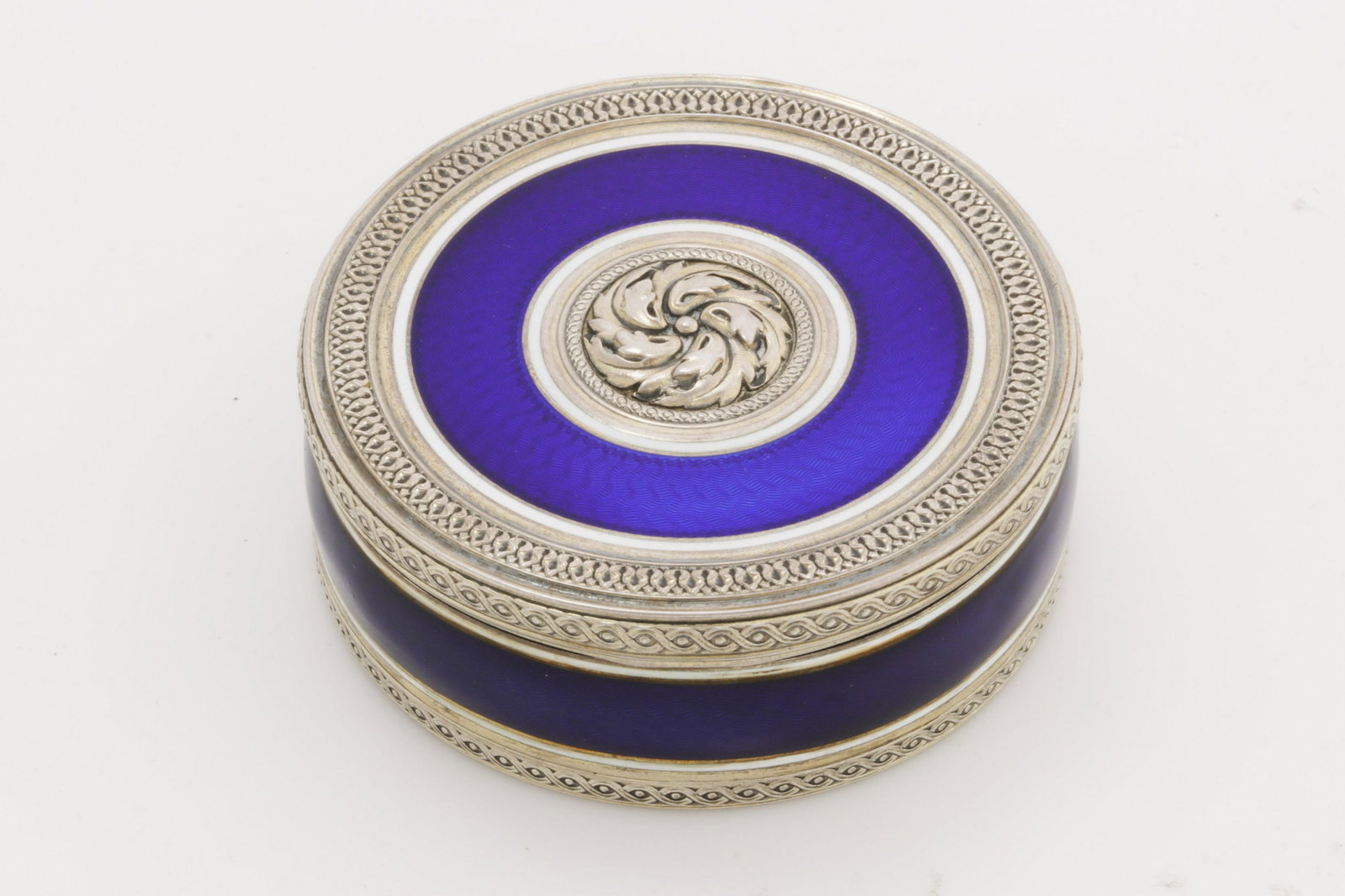 A French silver and enamel bonbonniere: A French first standard silver and enamel bonbonniere Henri Freres & Cie; retailed by Boin Taburet, Paris first quarter 20th century diameter 2 5/8in (6.5cm); gross weight approximately 3.5oz troy