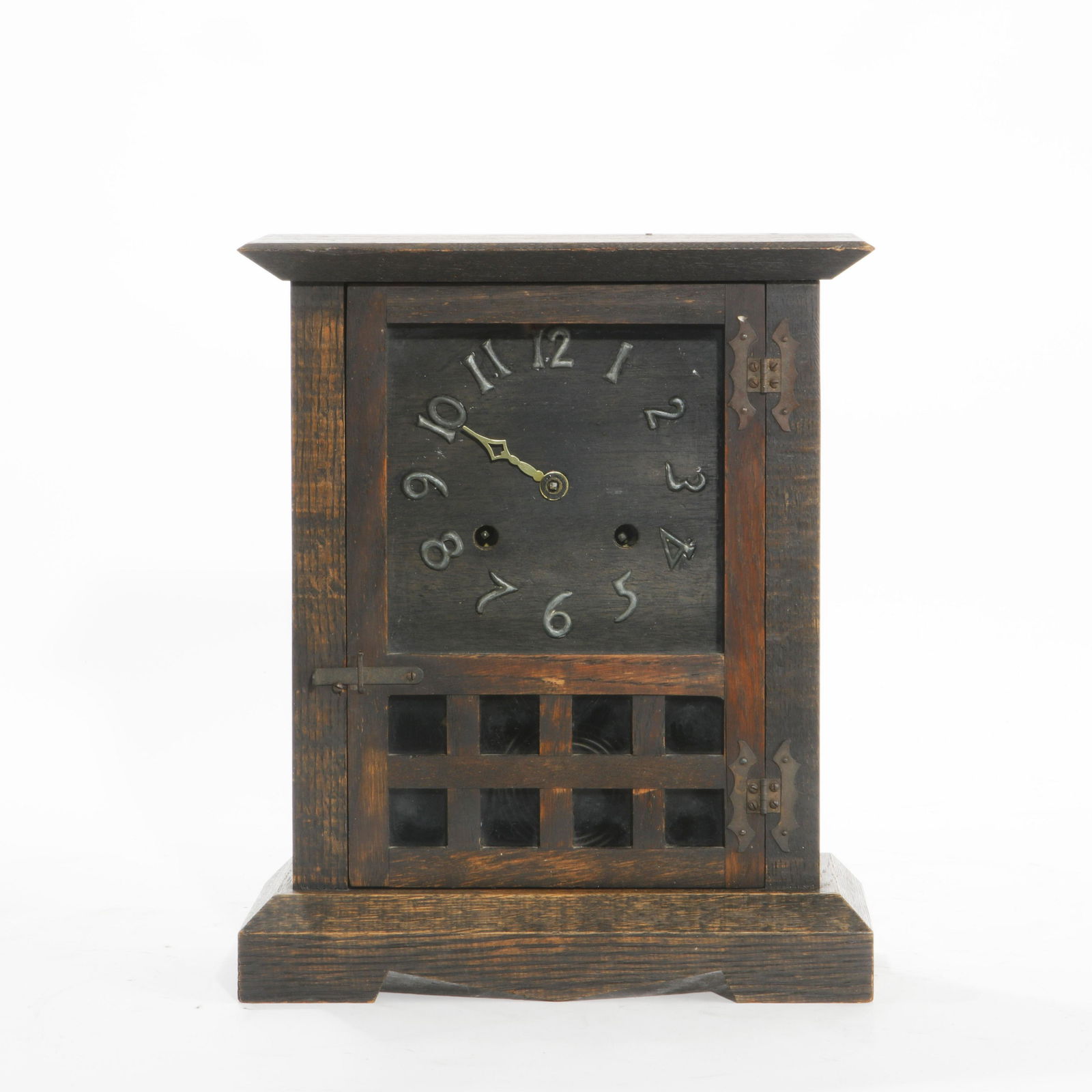 A New Haven Clock Co. Mission oak mantel clock: A New Haven Clock Co. Mission stained oak mantel clock first quarter 20th century The twin train movement striking on a gong. height 14in (35.5cm); width 12in (30cm); depth 5 1/2in (14cm)