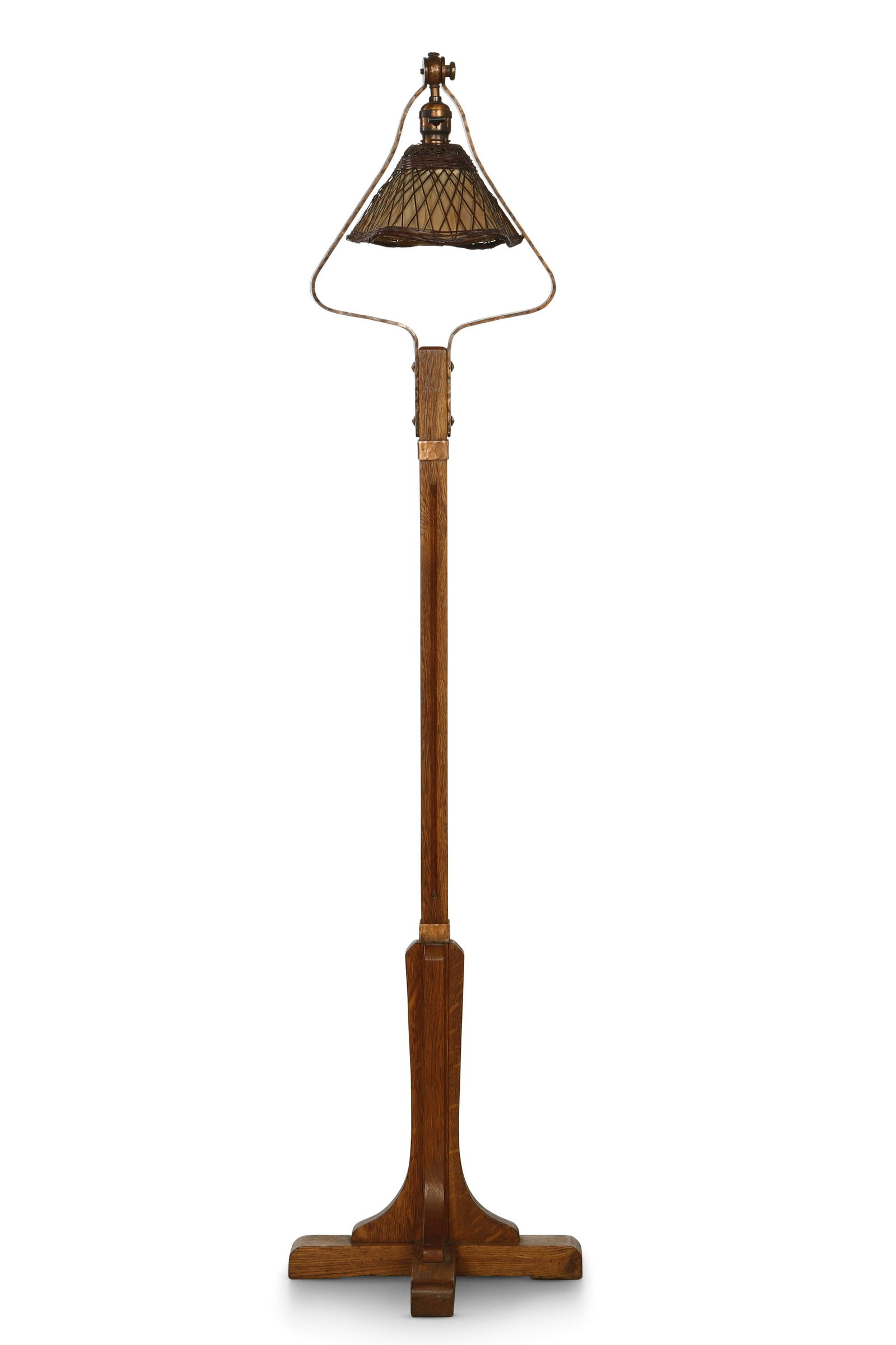 A Gustav Stickley Craftsman standing lamp, 500: A Gustav Stickley Arts & Crafts hammered copper mounted oak standing lamp, model 500 Craftsman Workshops circa 1912-1916 With black branded compass mark to underside. height 58in (147.5cm) Provenance: