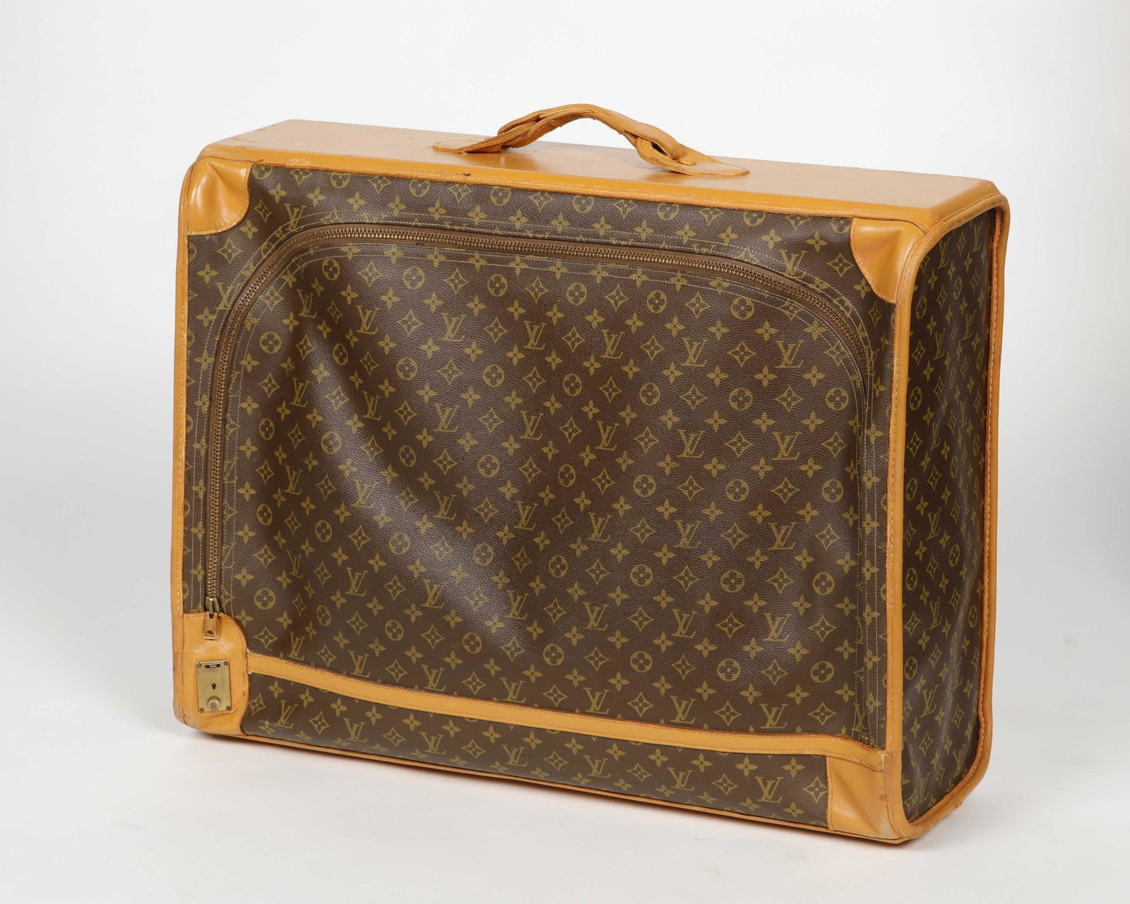 A Louis Vuitton monogram Pullman soft suitcase: A Louis Vuitton monogram Pullman soft-sided suitcase 1980s Brown and tan coated canvas with a rolled leater top handle and zipper closure. height 22 1/4in (565.5cm); width 28 1/4in (72cm); depth 9 1/4