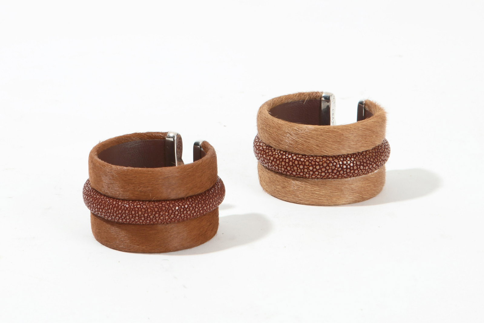 Pair of Alastair Crawford silver & shagreen cuffs: A pair of Alastair Crawford sterling silver mounted shagreen cuffs interior width 2in (5cm)