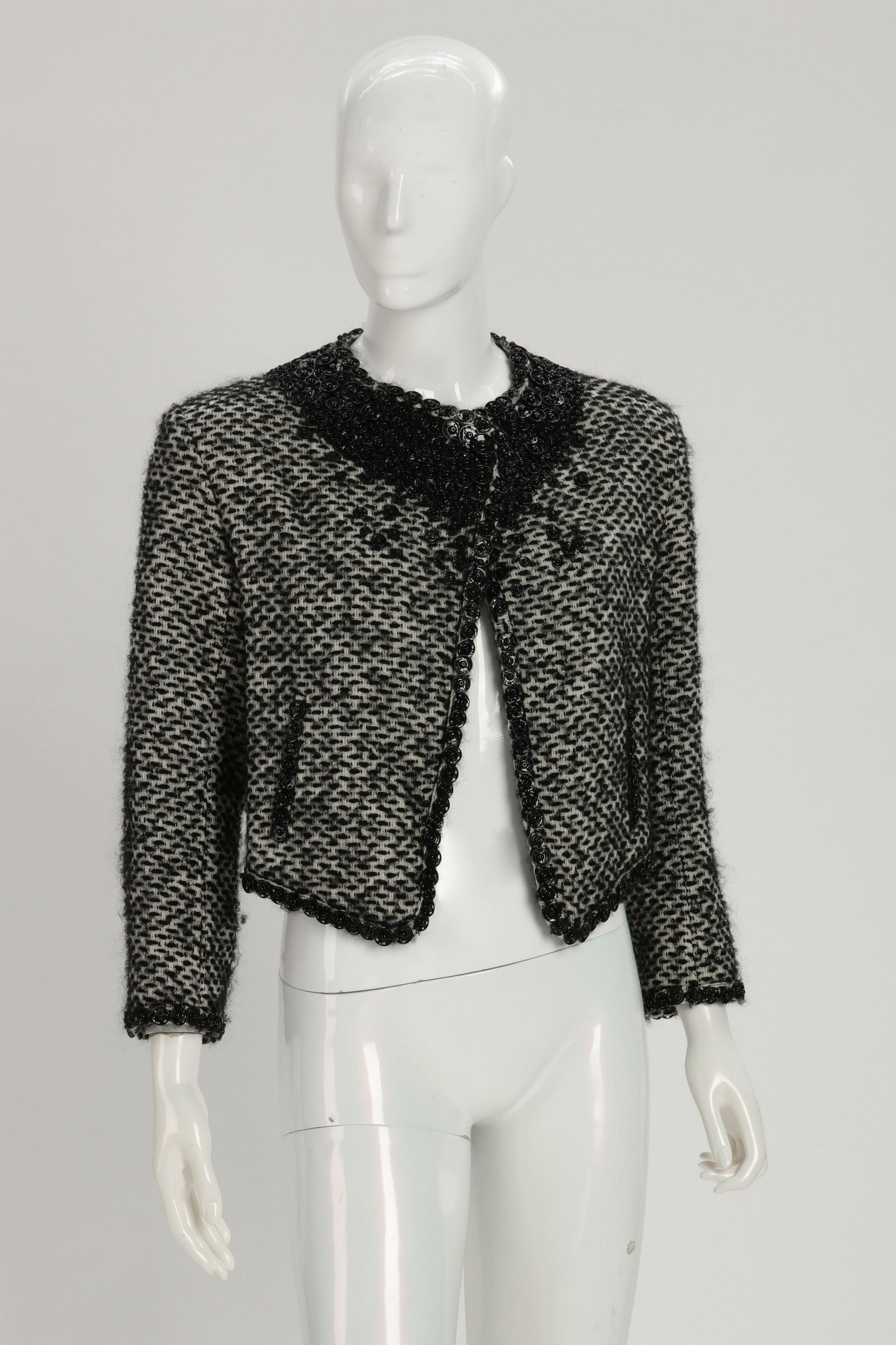 A Chanel knit sweater and a Gauthier tweed jacket: A Chanel knit 3/4 sleeve sweater, size 38, 2000s, together with a Jean Paul Gauthier black and white tweed jacket, size 8 1990s The cashmere Chanel sweater with three quarter sleeves hip pocket and fi