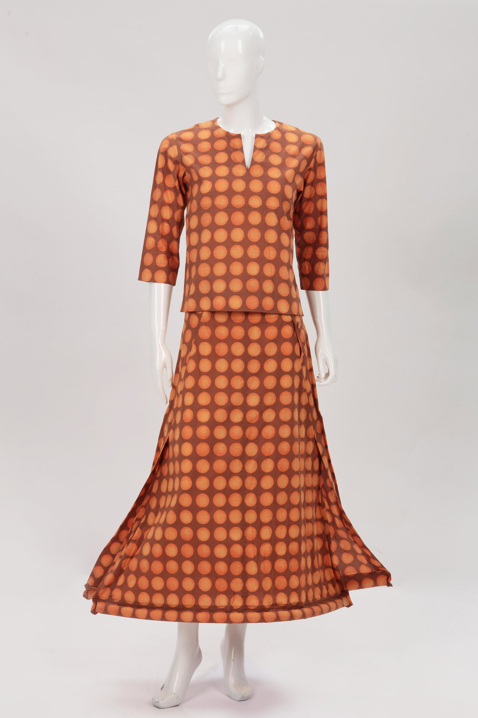 An Issey Miyake Red Eyes Tribe tunic and skirt: An Issey Miyake tan and orange polka dot tunic and floating hem skirt, jacket size 2 and skirt size 3 Spring/Summer 2001 The Red Eyes Tribe long sleeve cotton tunic with no collar and cotton inflated 