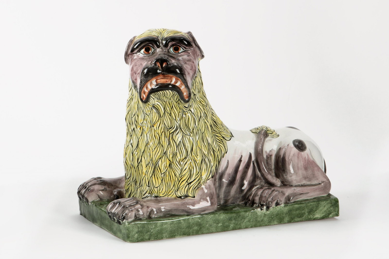 An Italian glazed earthenware model of a lion: An Italian glazed earthenware model of a lion 20th century Black painted Italy S6366 to underside. height 13 1/4in (33.5cm)