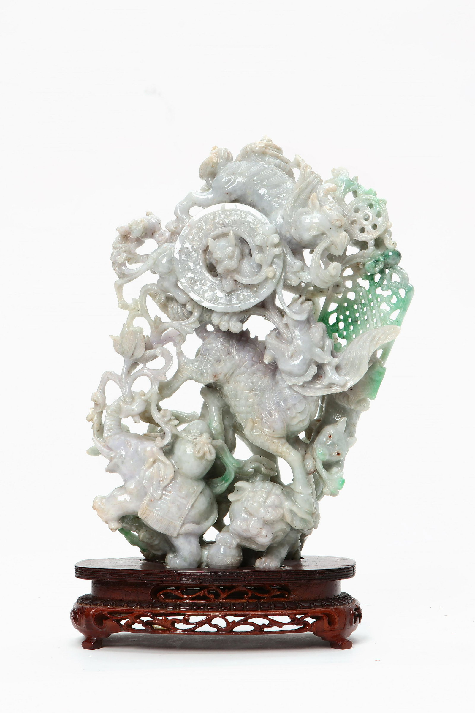 A Chinese hardstone group of animals: A Chinese green and purple hardstone group of dragon, elephant and temple lion On stand. height 12in (30.5cm); width 8in (20.25cm) Provenance: Property from the Collection of Yasuko and Maury Kraines.