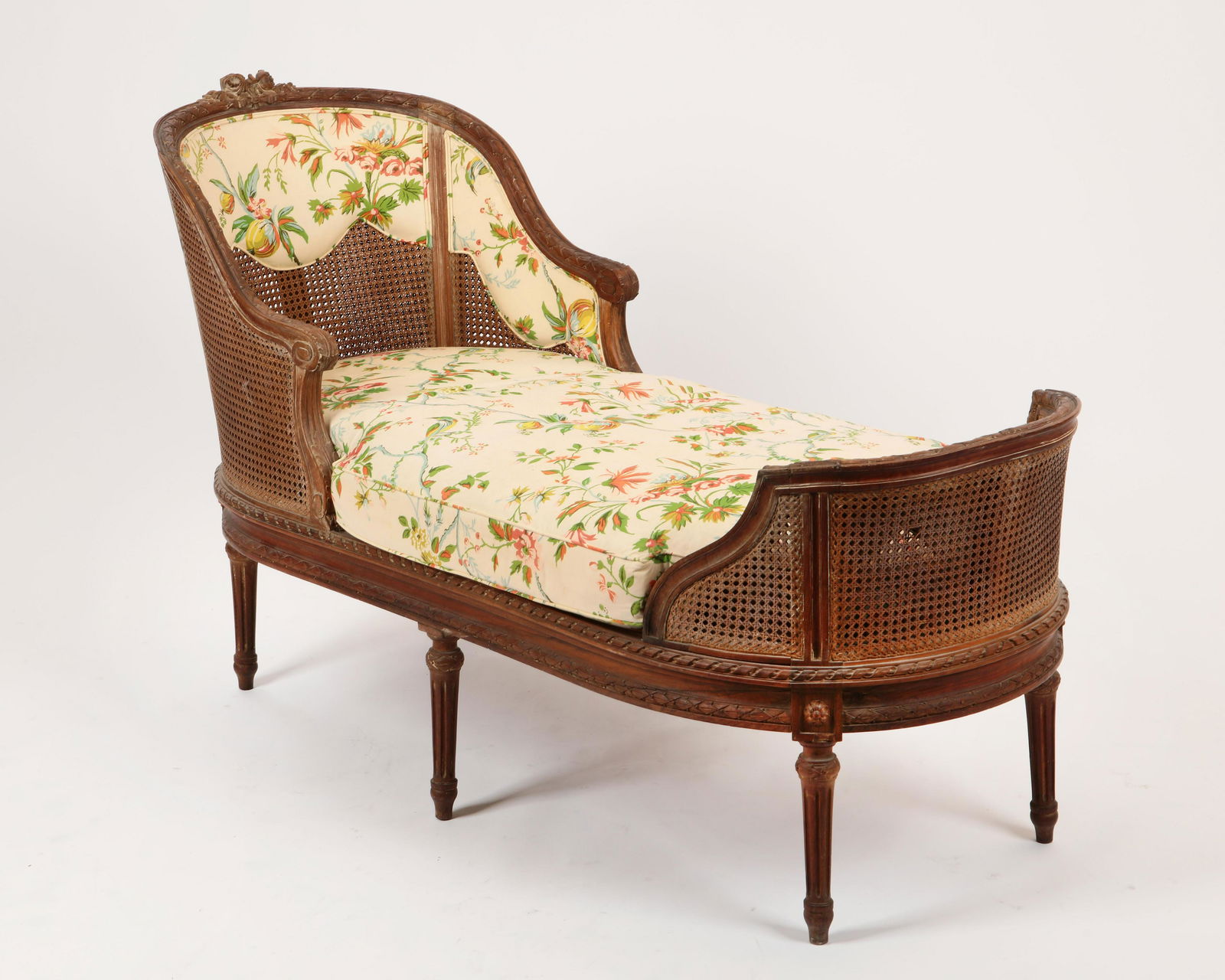 A Louis XVI and caned chaise lounge: A Louis XVI and caned chaise lounge 19th century height 35 3/4in (90.5cm); width 62 3/4in (159.5cm); depth 23 3/4in (60.5cm)