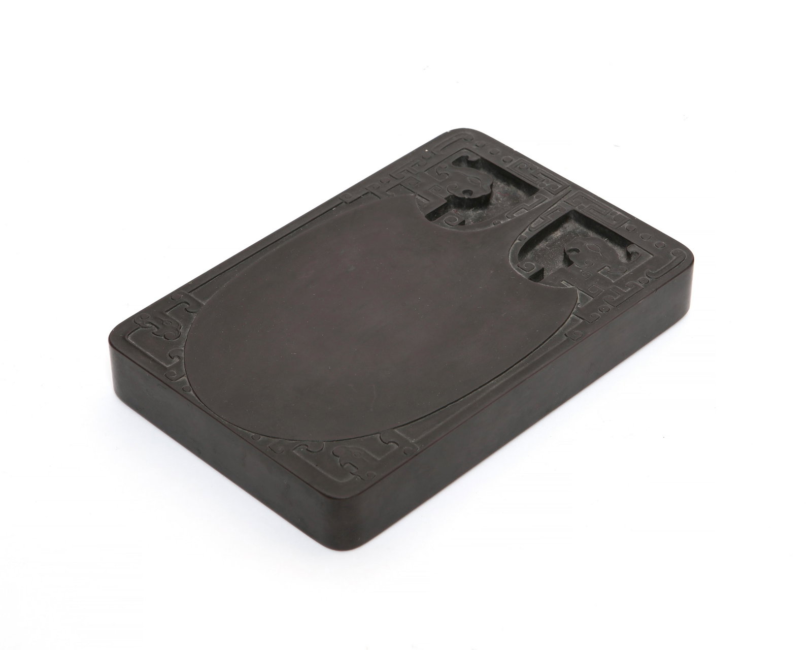 A Chinese inkstone: A Chinese inkstone 20th century height 1in (2.5cm); width 4 3/4in (12cm); depth 7in (17.5cm)