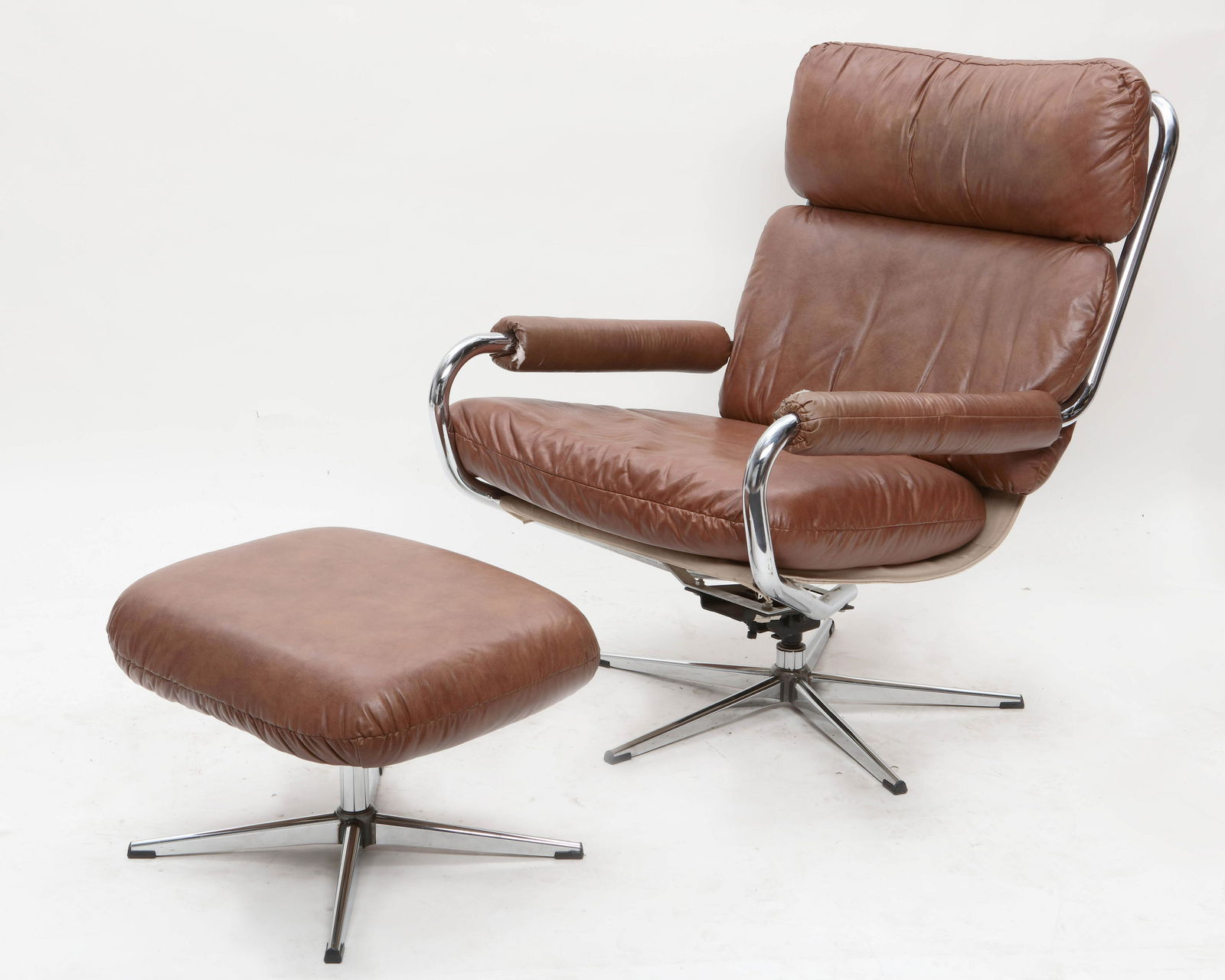 A Selig chrome and leather lounge chair & ottoman: A Selig chrome and leather upholstered lounge chair and ottoman mid 20th century height 38 1/2in (98cm); width 28in (71cm); depth of seat 22in (56cm) Provenance: Selected Pieces from The Gallery @ REI