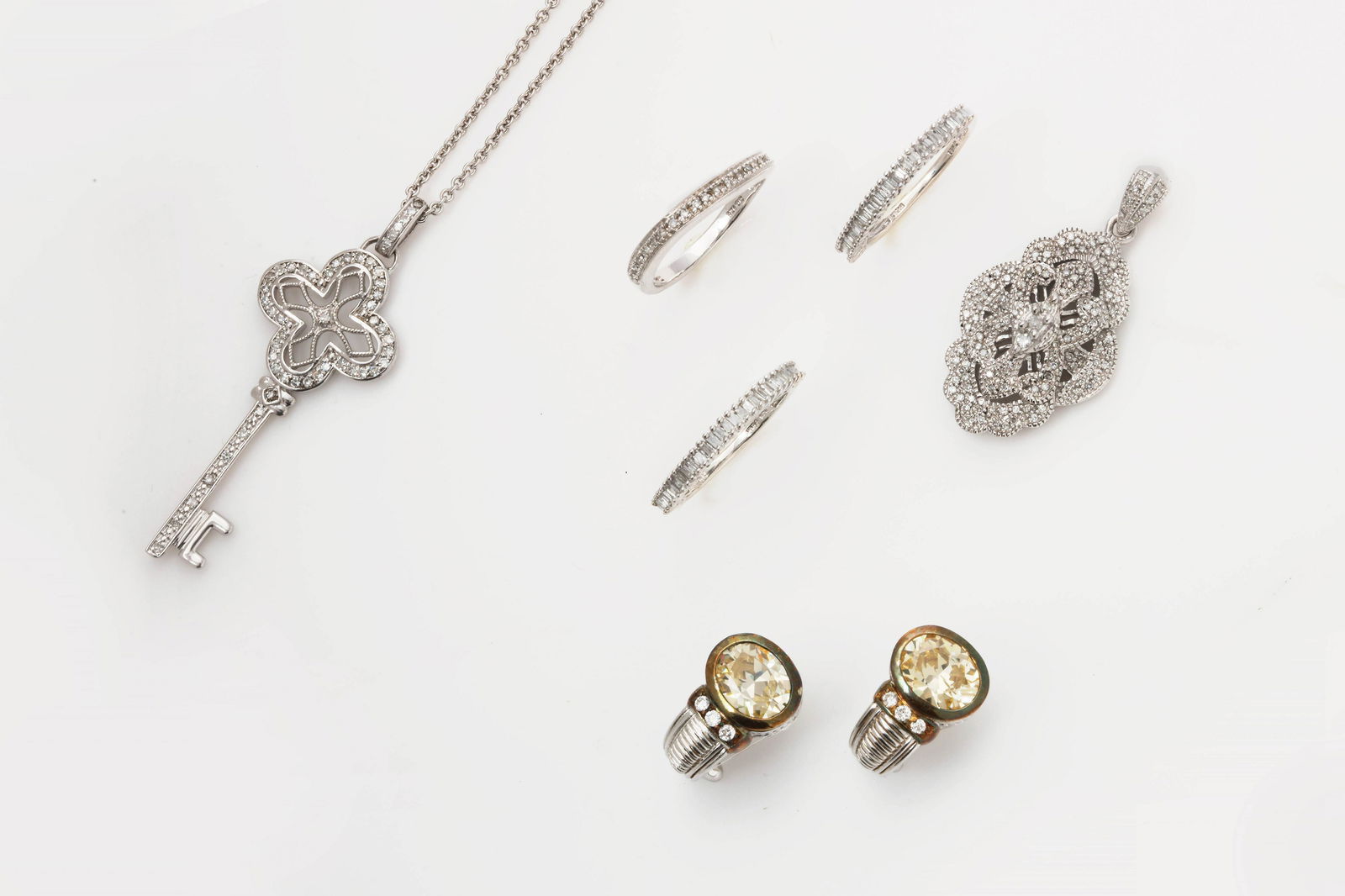 Seven pieces of diamond, silver and gold jewelry: A seven piece collection of diamond, sterling silver and 18k gold jewelry Judith Ripka and others comprising one pendant on chain, one pendant, a pair of earclips signed Judith Ripka and three rings;
