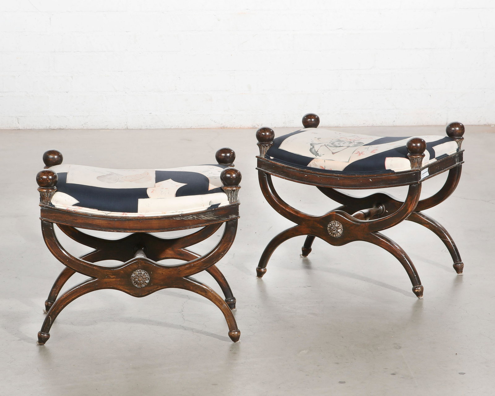 A pair of Empire style mixed wood curule stools: A pair of Empire style mixed wood curule stools 20th century height 20in (50.5cm); width 22in (56cm); depth 15 1/2in (39.5cm) Provenance: Property from the Collection of Yasuko and Maury Kraines., Bev