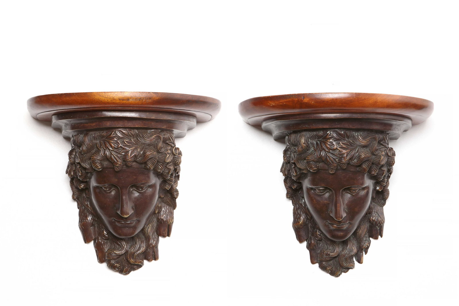 A pair of patinated bronze and mahogany wall brackets: A pair of Neoclassical style patinated bronze and mahogany wall brackets 20th century height 10 3/4in (27.5cm); width 11 1/2in (29cm); depth 8 1/2in (21.5cm)