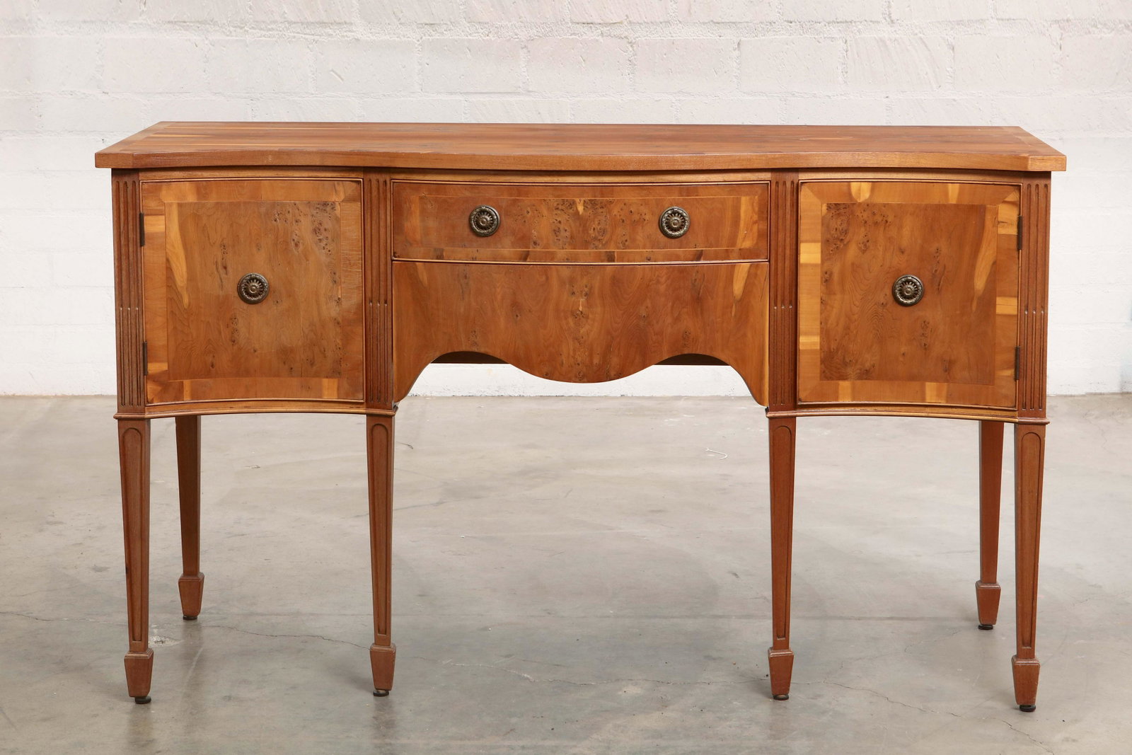 A George III style burlwood sideboard: A George III style crossbanded and inlaid burlwood sideboard modern height 35in (91.5cm); width 59in (150cm); depth 22 1/4in (56.5cm)