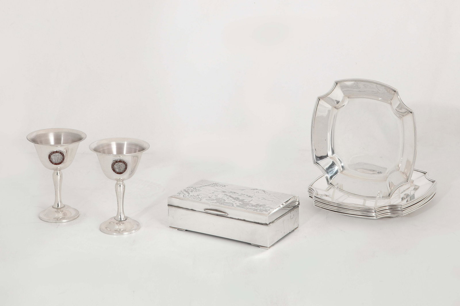An eleven piece group of sterling silver tableware: An eleven piece group of American and Japanese sterling silver tableware various makers 20th century Comprising a Japanese cigarette box, a set of eight Whiting bread plates and a pair of Medical Golf