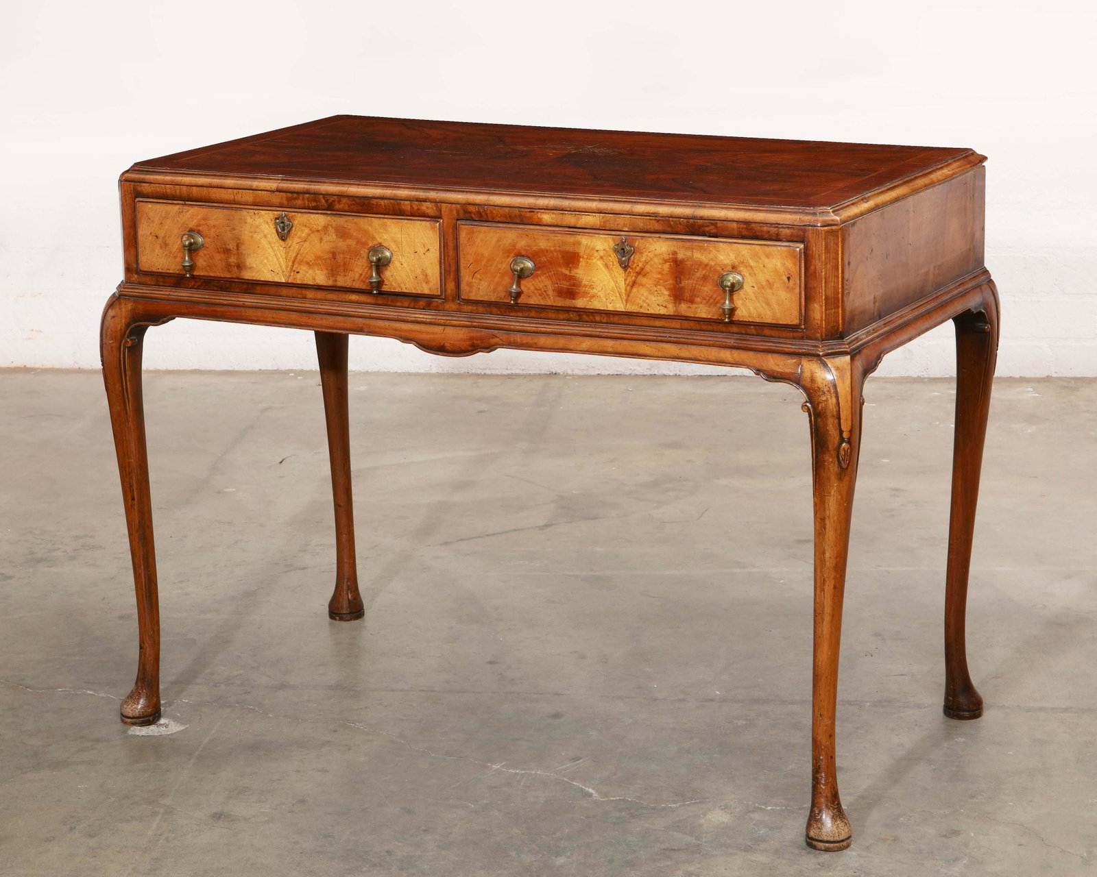 A George II style walnut side table: A George II style walnut side table late 19th/early 20th century height 32 1/2in (82.5cm); width 43 1/2in (109.25cm); depth 23in (58.5cm) Provenance: Property from the Bobby Burns family.