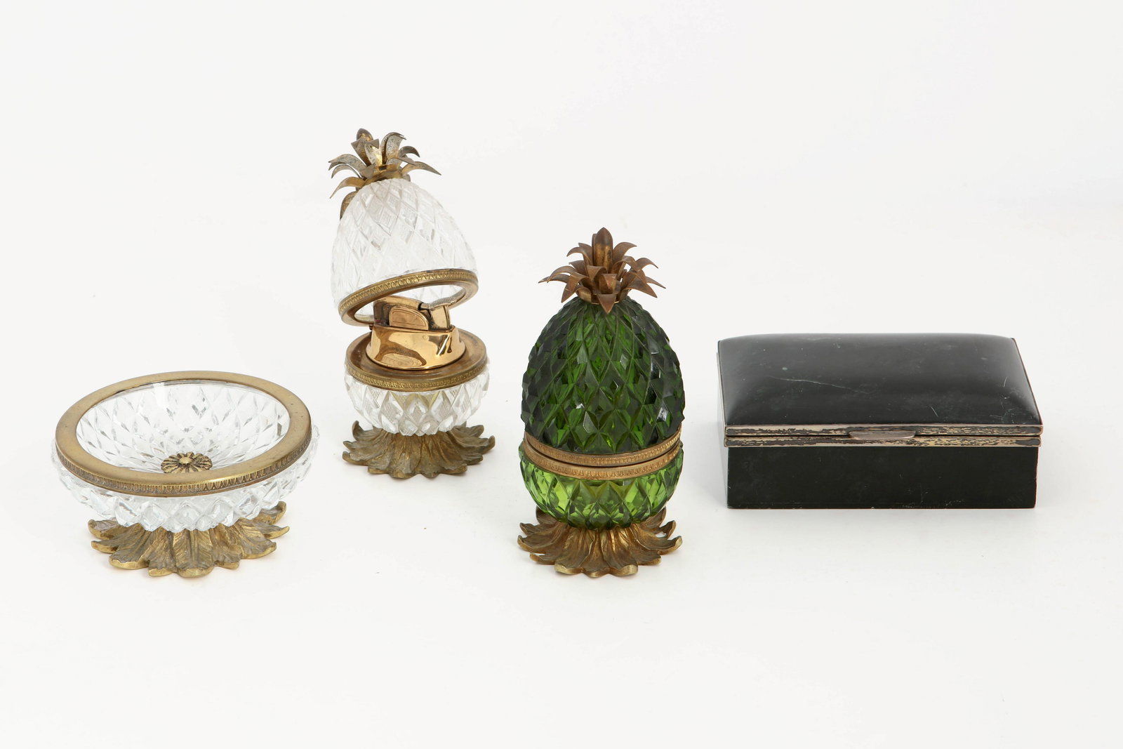 Four glass and hardstone smoking accessories: A four piece collection of Continental mounted glass and hardstone smoking accessories 20th century Comprising a sterling silver mounted hardstone cigarette box, a pair of pineapple form table lighter