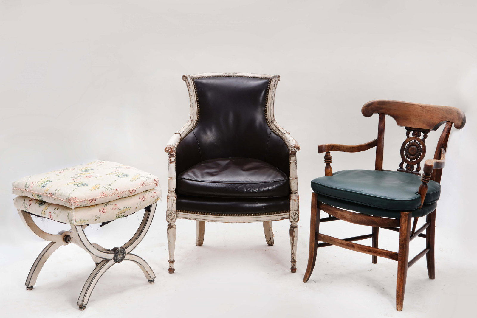 A Directoire white painted bergere and two other: A Directoire white painted bergere circa 1800 Together with a Continental stained fruitwood and elm armchair, 19th century and a Neoclassical style white painted stool, 20th century. (3) The bergere h