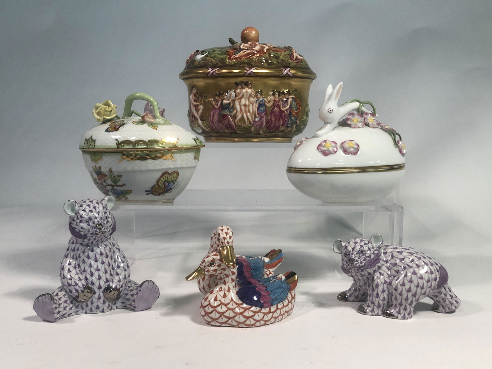 A group of five Herend porcelain articles: A group of five Herend porcelain articles Comprising two covered boxes, two first edition models of bears, a model of two ducks, each with blue printed factory mark; together with a Capodimonte relief