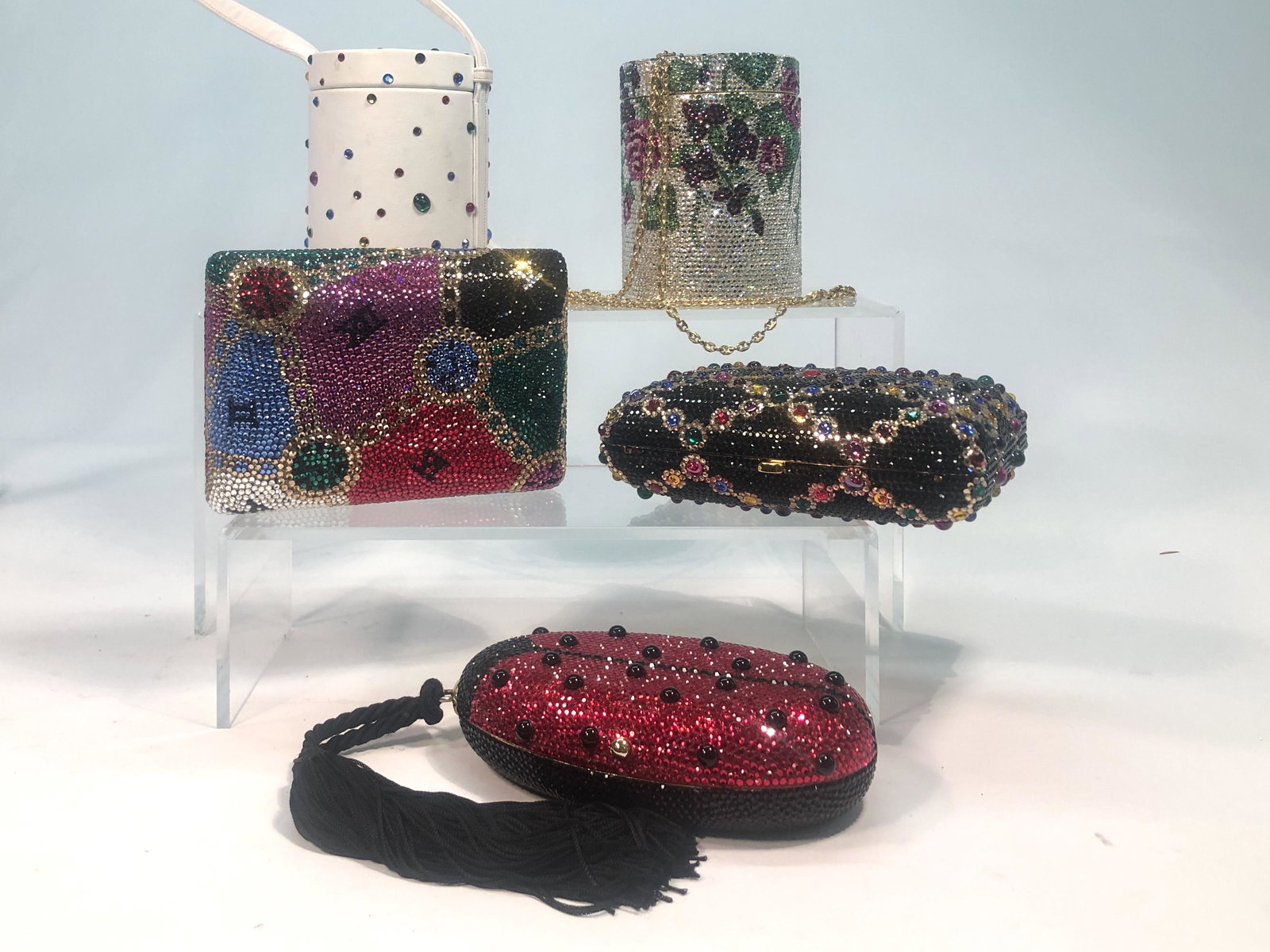 Five Michaelere jeweled minaudiere bags: Five Michaelere 'jeweled' minaudiere bags Comprising two rectangular with tuck away gold tone shoulder chains; a ladybug form clutch with tassel handle, containing a ladybug pill box; two cannister fo