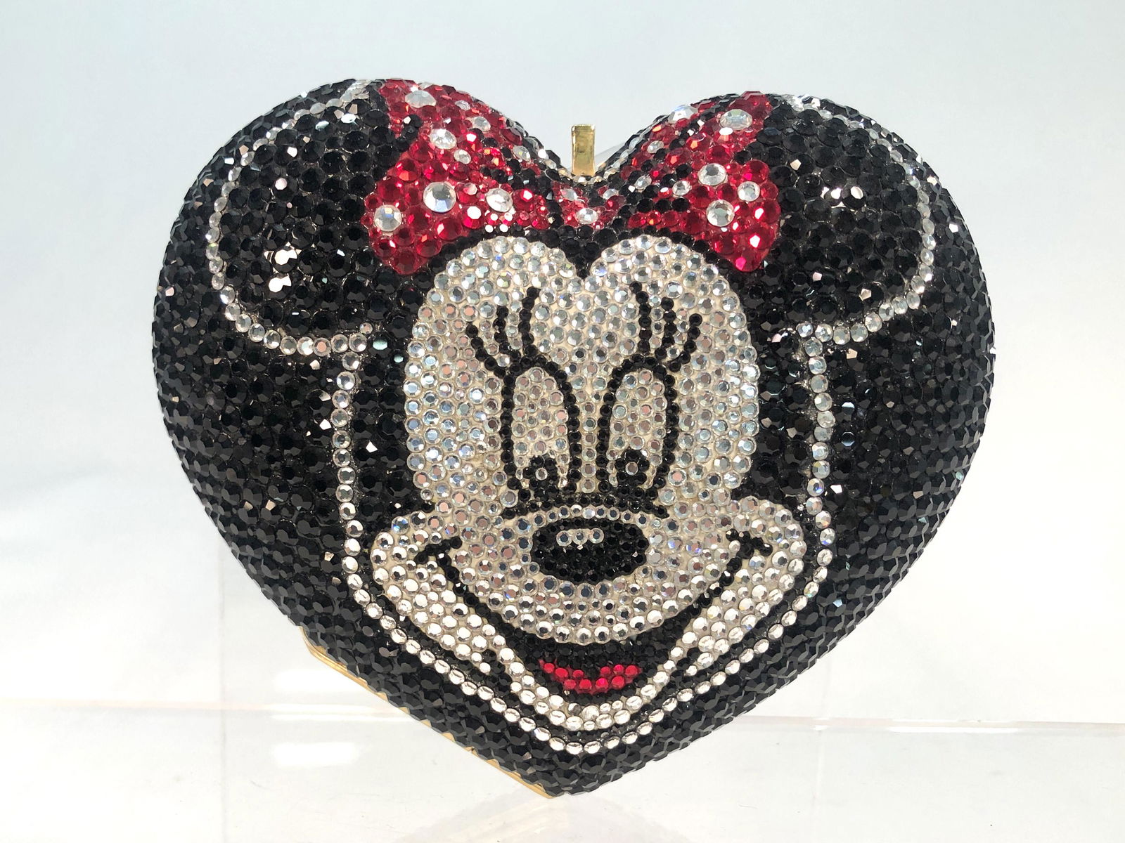 A Kathrine Baumann Minnie Mouse minaudiere: A Kathrine Baumann Minnie Mouse minaudiere The interior lined in metallic leather, with tuck away gold tone and 'jeweled' shoulder chains, applied factory label. height 4 1/2in (11.5cm); width 5 1/4in