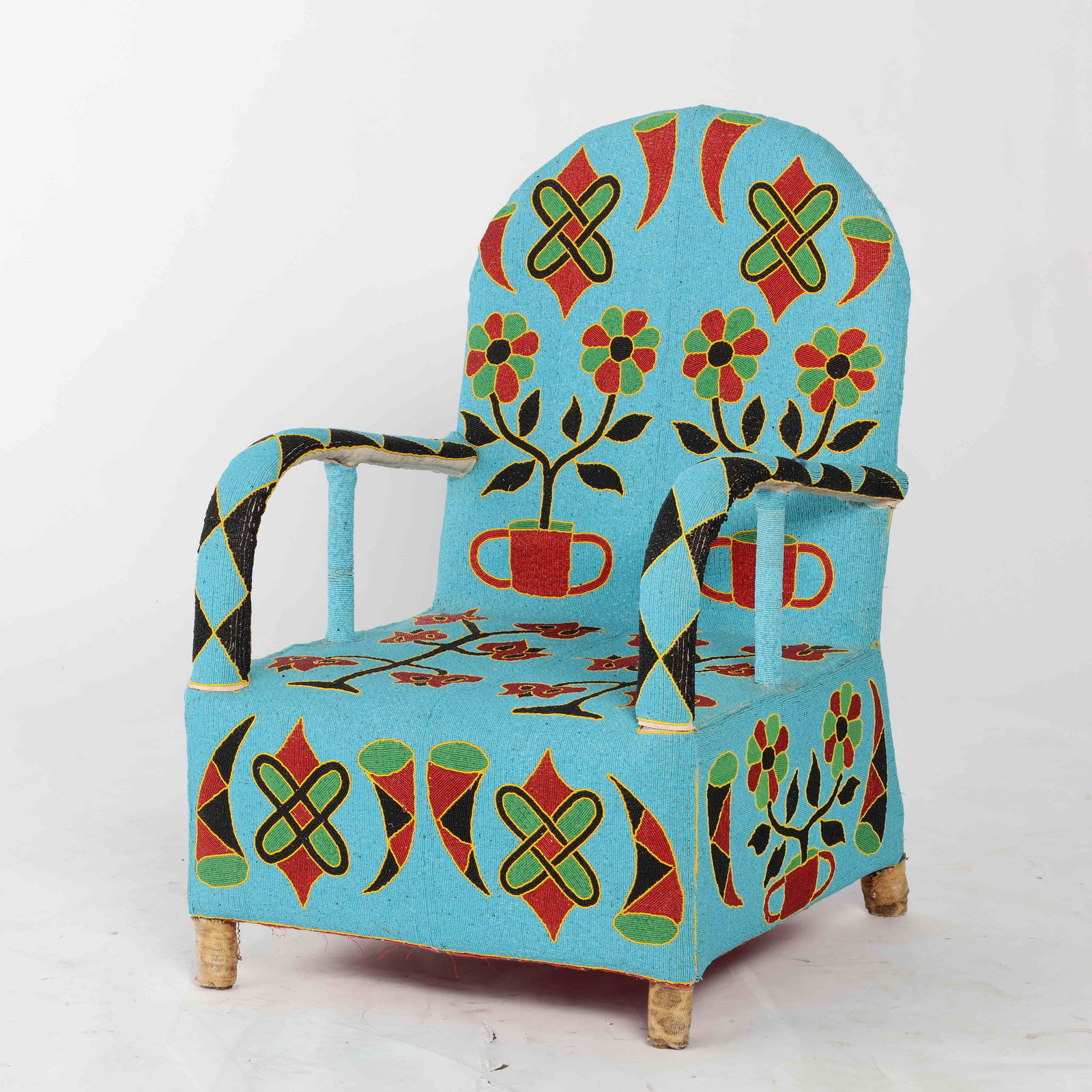African Yoruba beadwork open armchair, Nigeria: An African Yoruba floral decorated beadwork open armchair Nigeria post 1950 height 38 1/2in (97.5cm); width 25in (63.5cm); depth of seat 21 1/2in (54.5cm)Provenance: Property from the Estate of June D