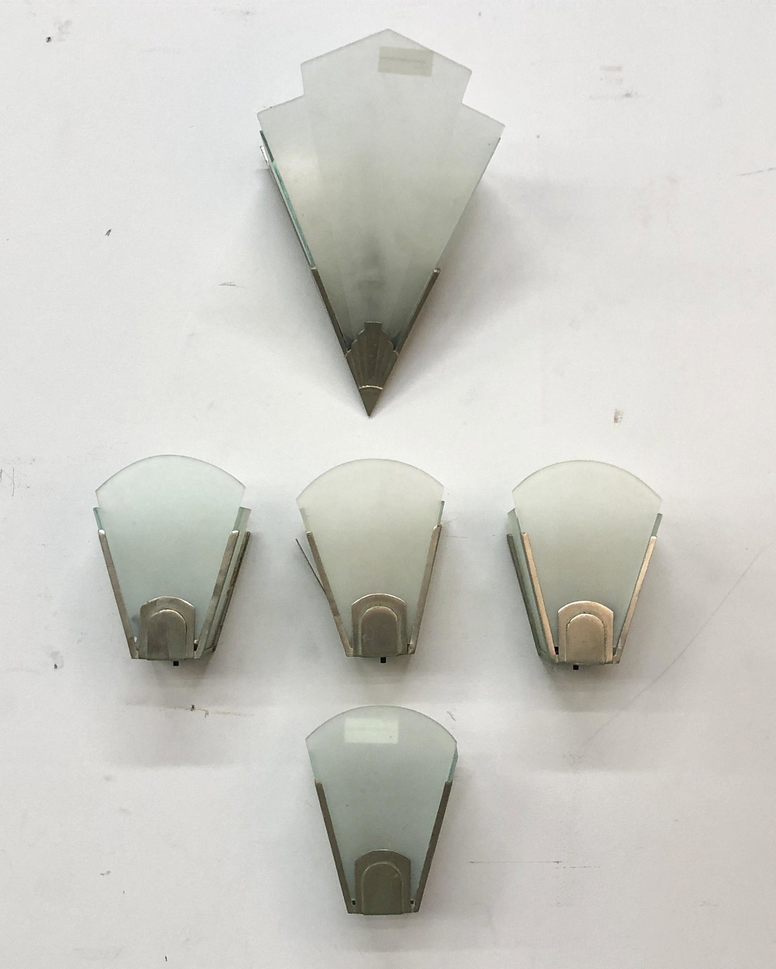 Four Art Deco style chrome & glass sconces: A set of four Art Deco style chromed metal and frosted glass wall lights together with another example (5) height 8in (20cm); width 6in (15cm); depth 4in (10cm)Provenance: Property from a Private Bel 
